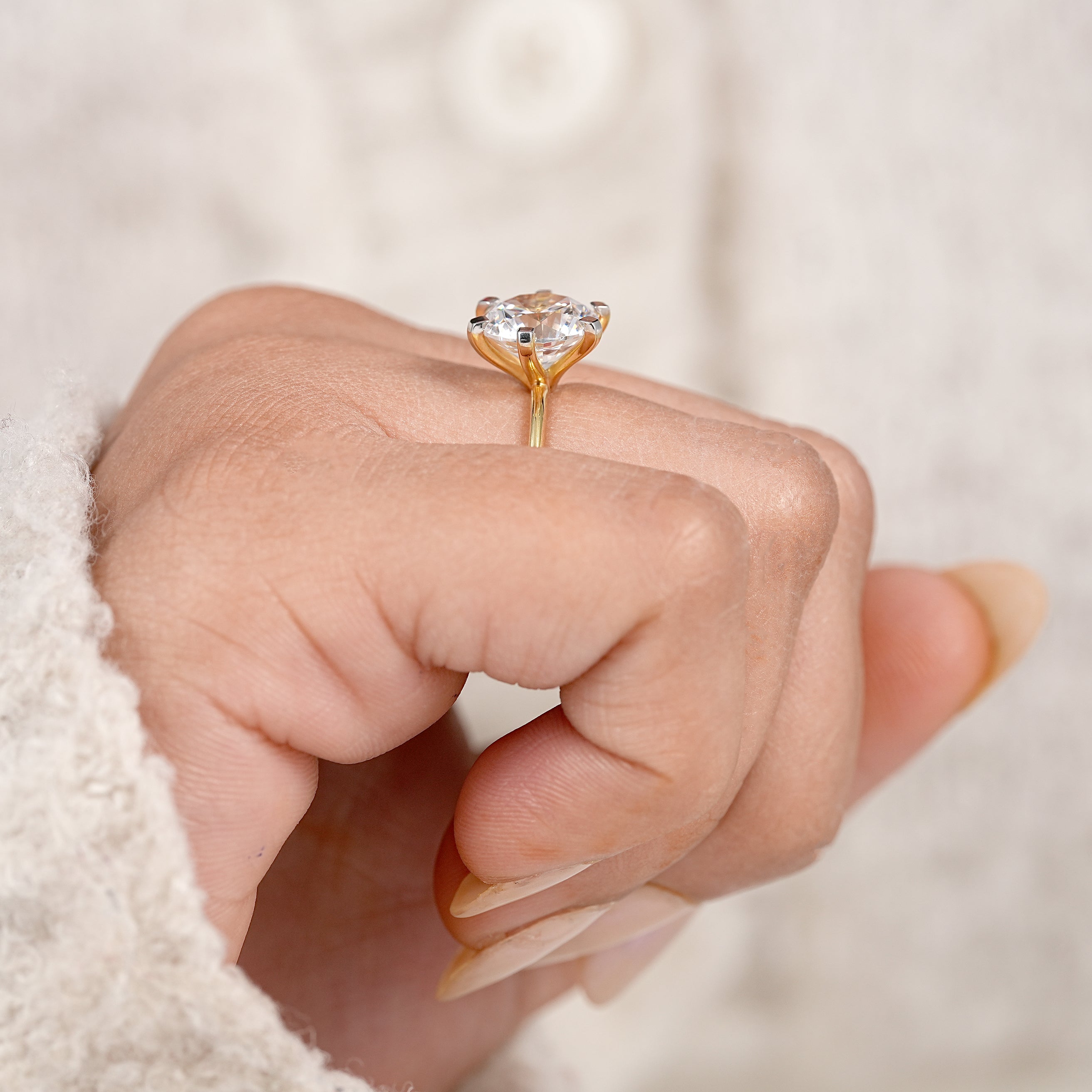 Modern round solitaire engagement ring with polished yellow gold finish