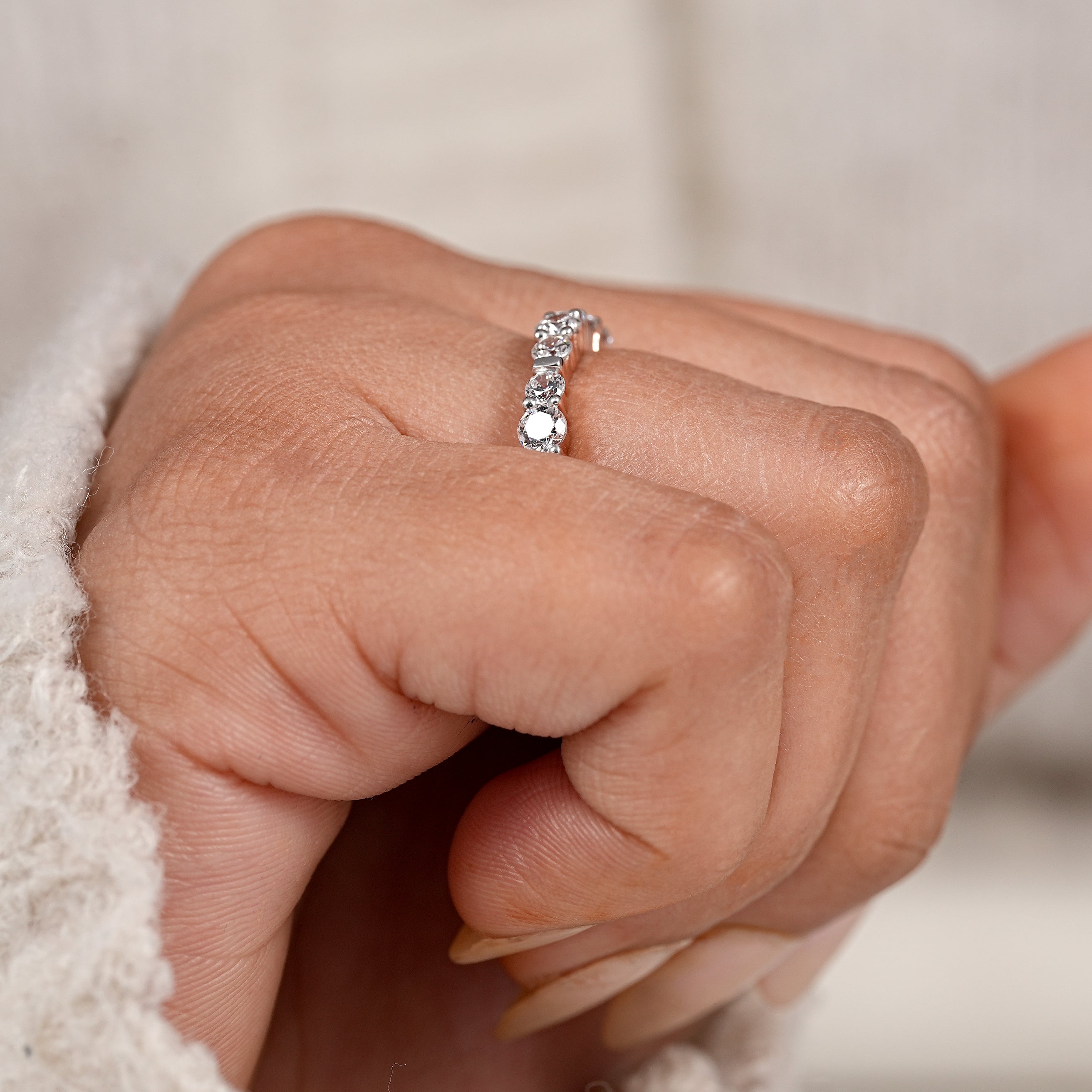 Delicate rose gold eternity wedding ring with brilliant round diamond accents