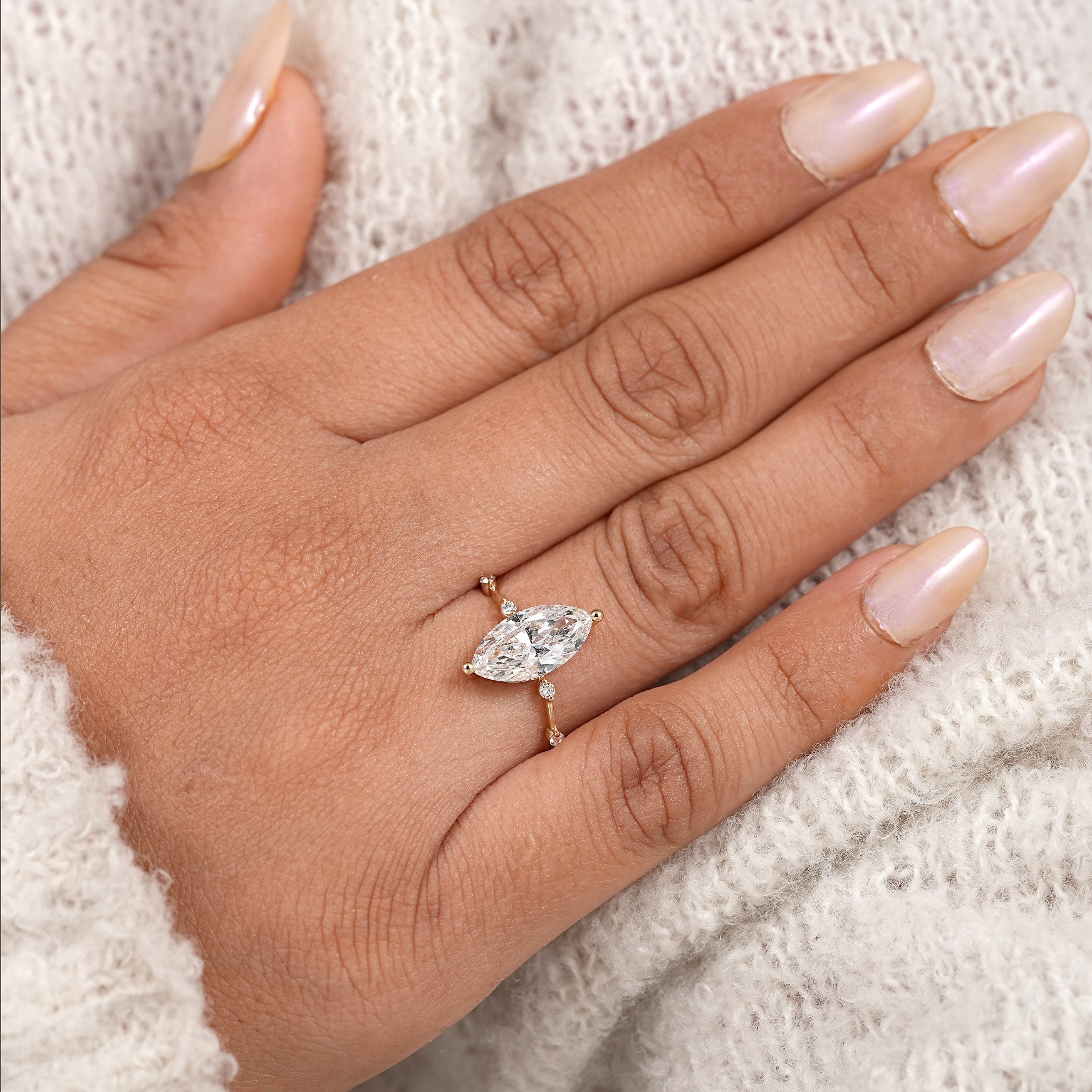 Marquise shaped lab created diamond engagement ring with station set diamonds