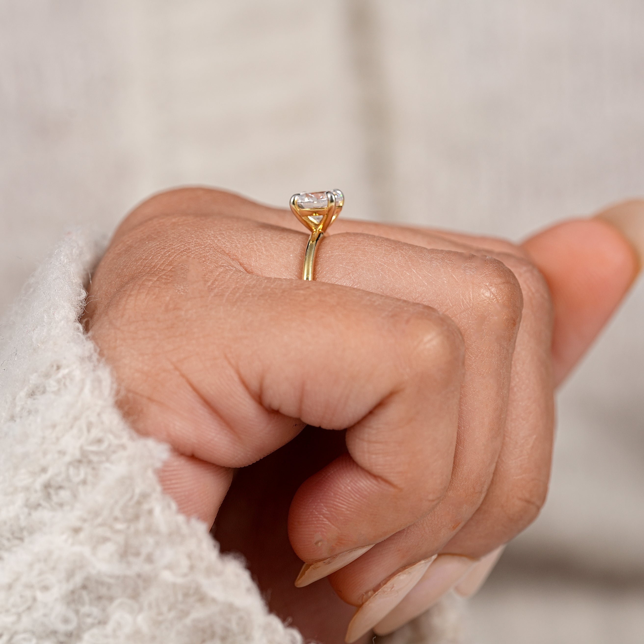 Modern round solitaire engagement ring with polished yellow gold finish