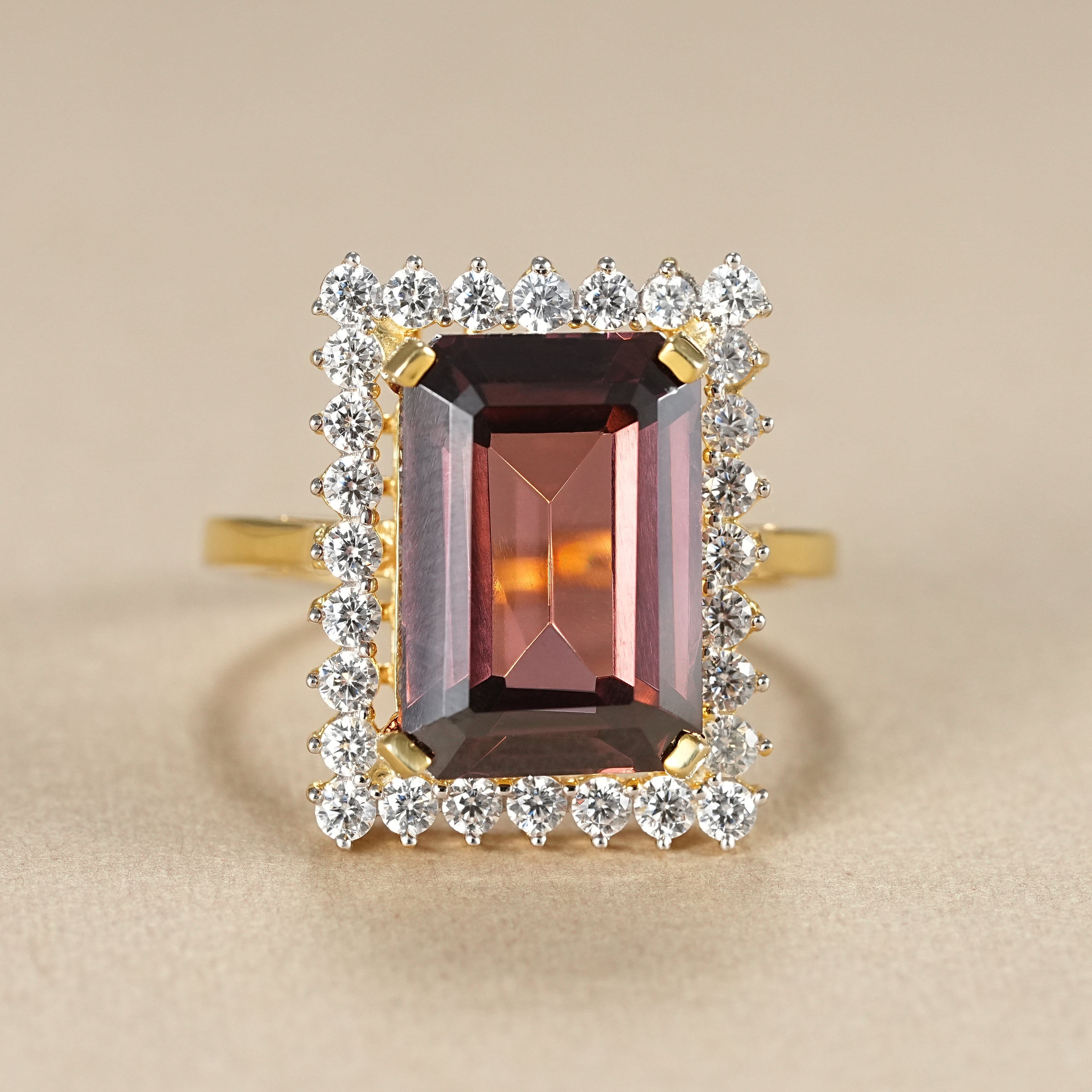 Emerald cut garnet halo engagement ring in yellow gold with diamond accents