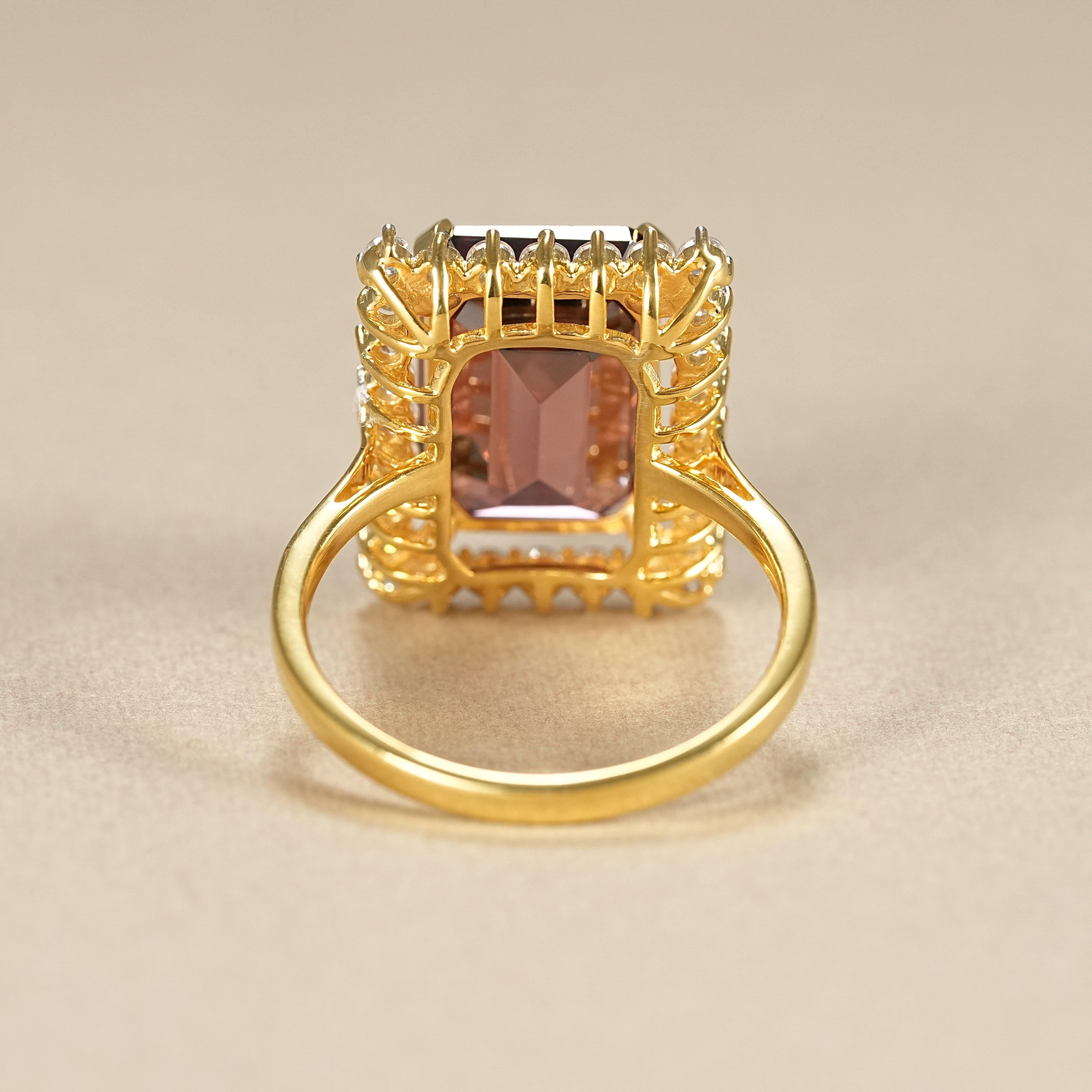 Deep red garnet engagement ring with emerald cut gemstone and diamond frame