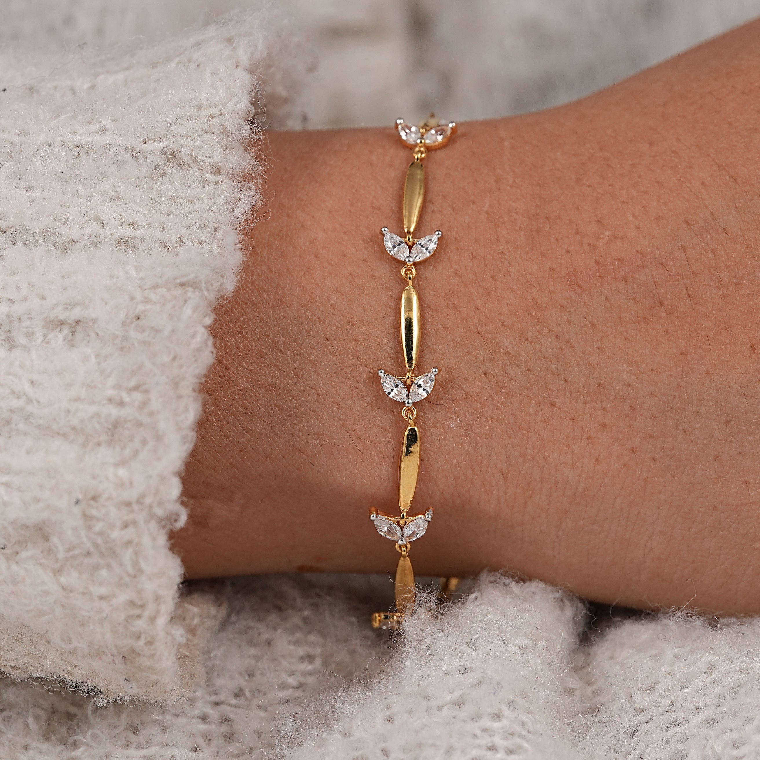 Modern station bracelet with marquise cut diamond floral link design