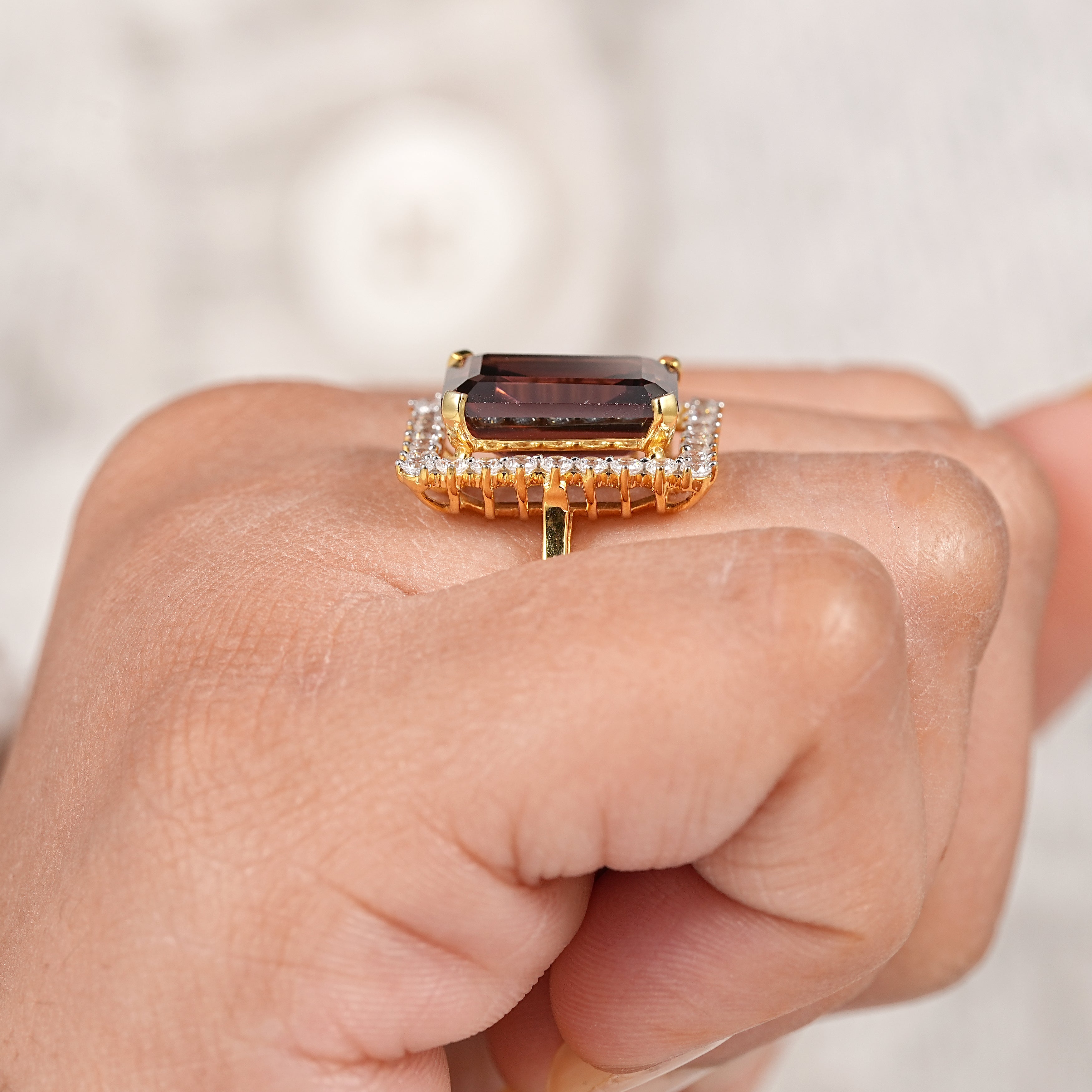 Geometric emerald cut garnet engagement ring with sparkling diamond surround