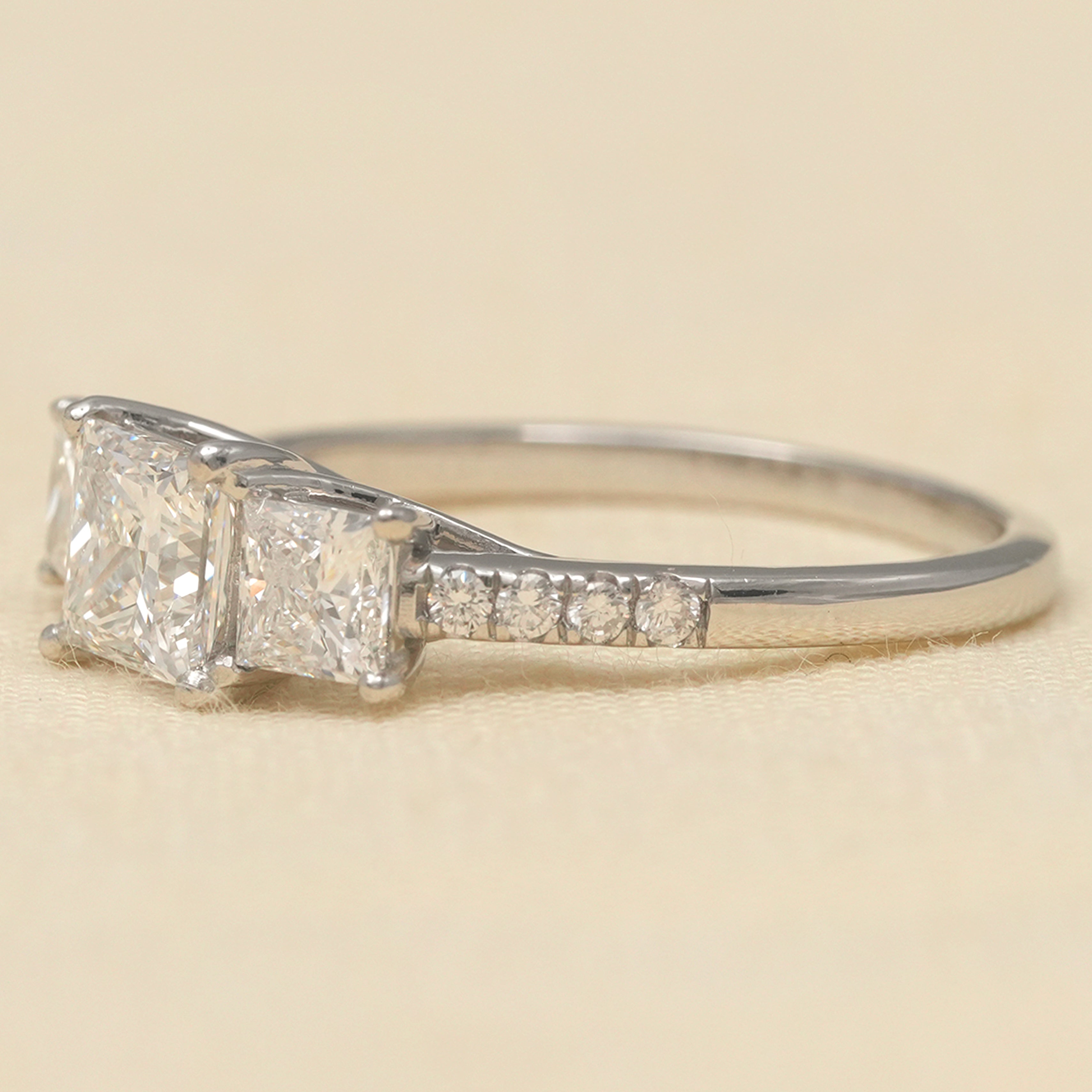 Princess cut three stone engagement ring showcasing lab grown diamond brilliance