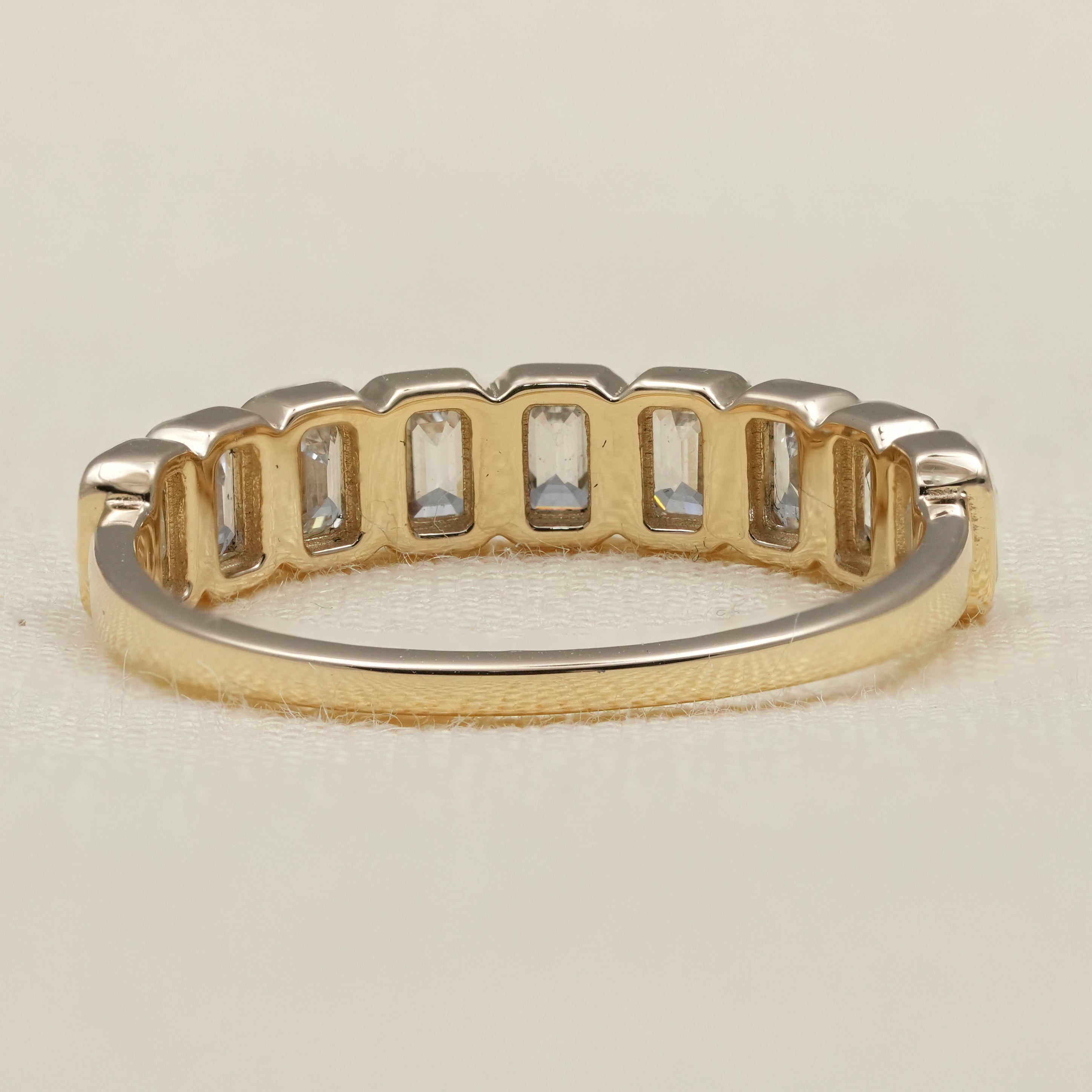 Bezel set emerald cut eternity band symbolizing love with lab grown diamonds