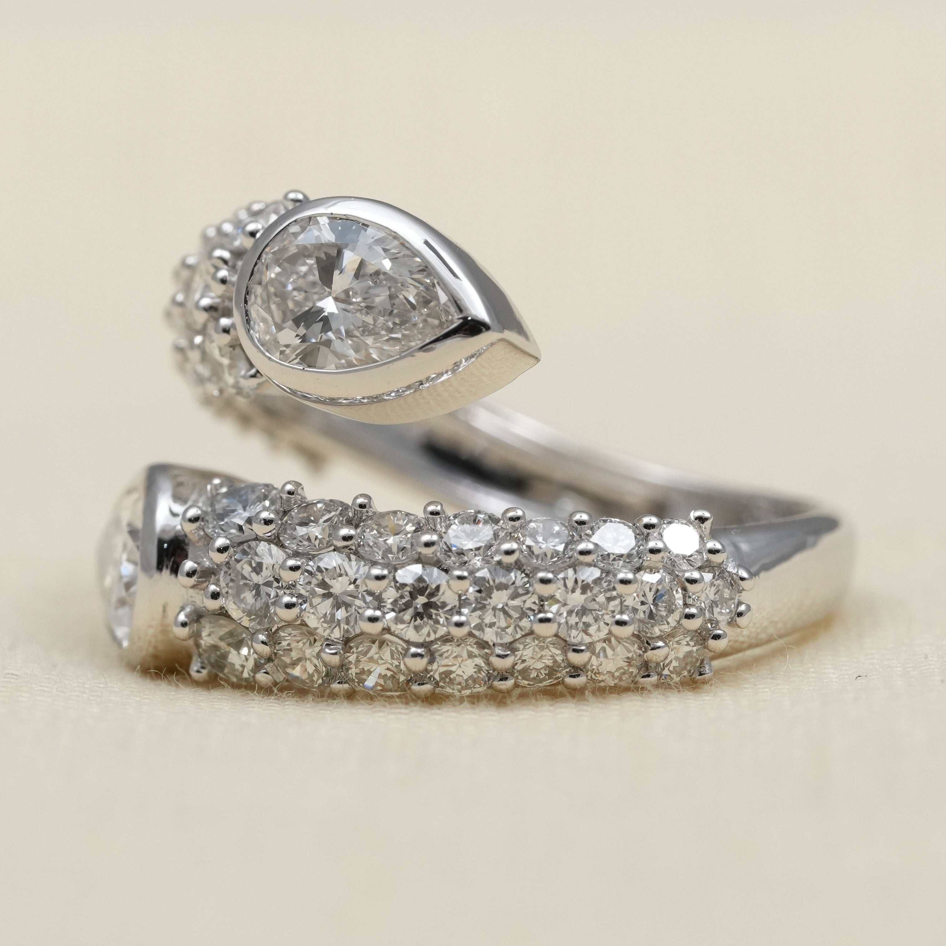 Elegant bypass ring designed with pear lab grown diamonds sparkling pavé
