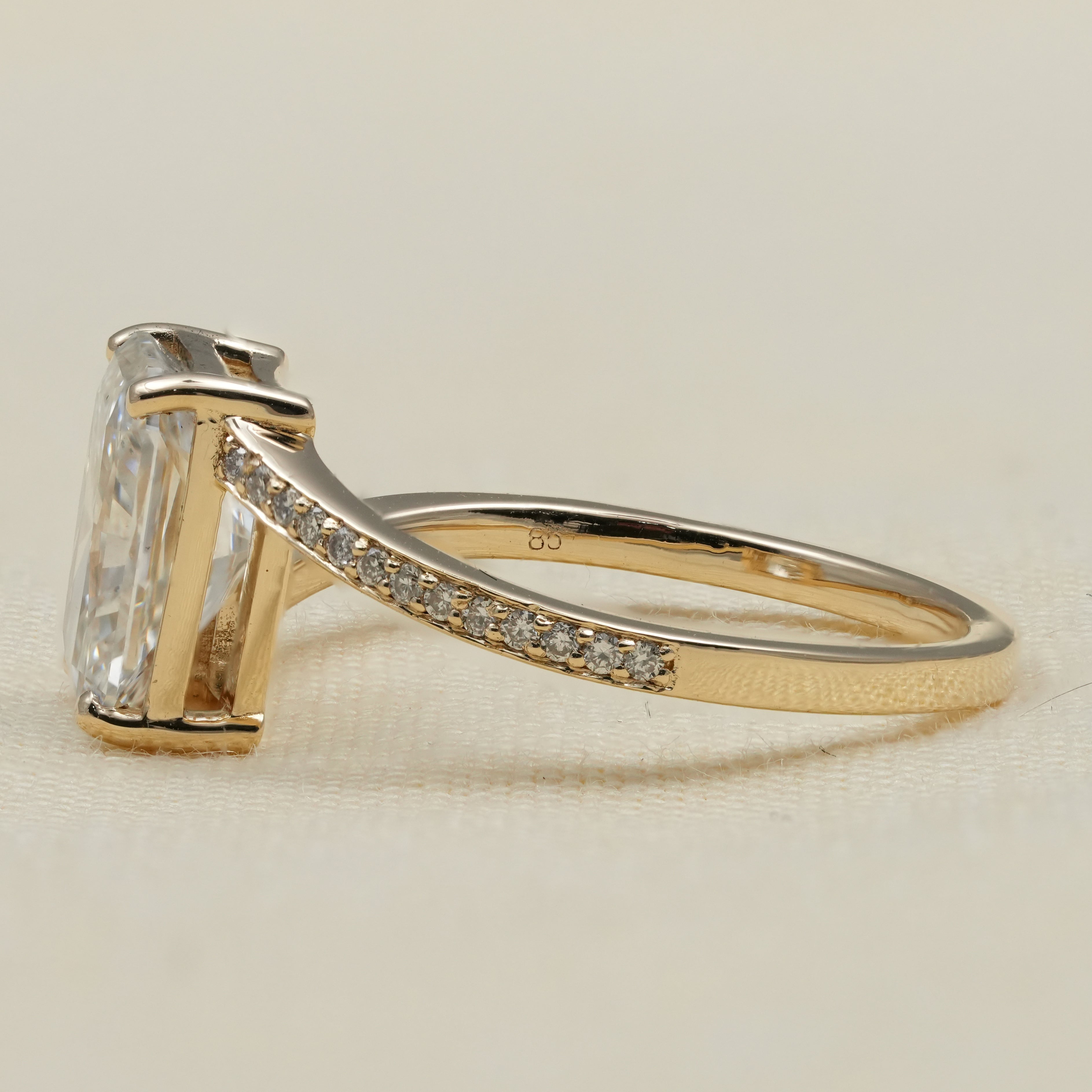 Radiant cut engagement ring featuring lab grown diamond bypass band