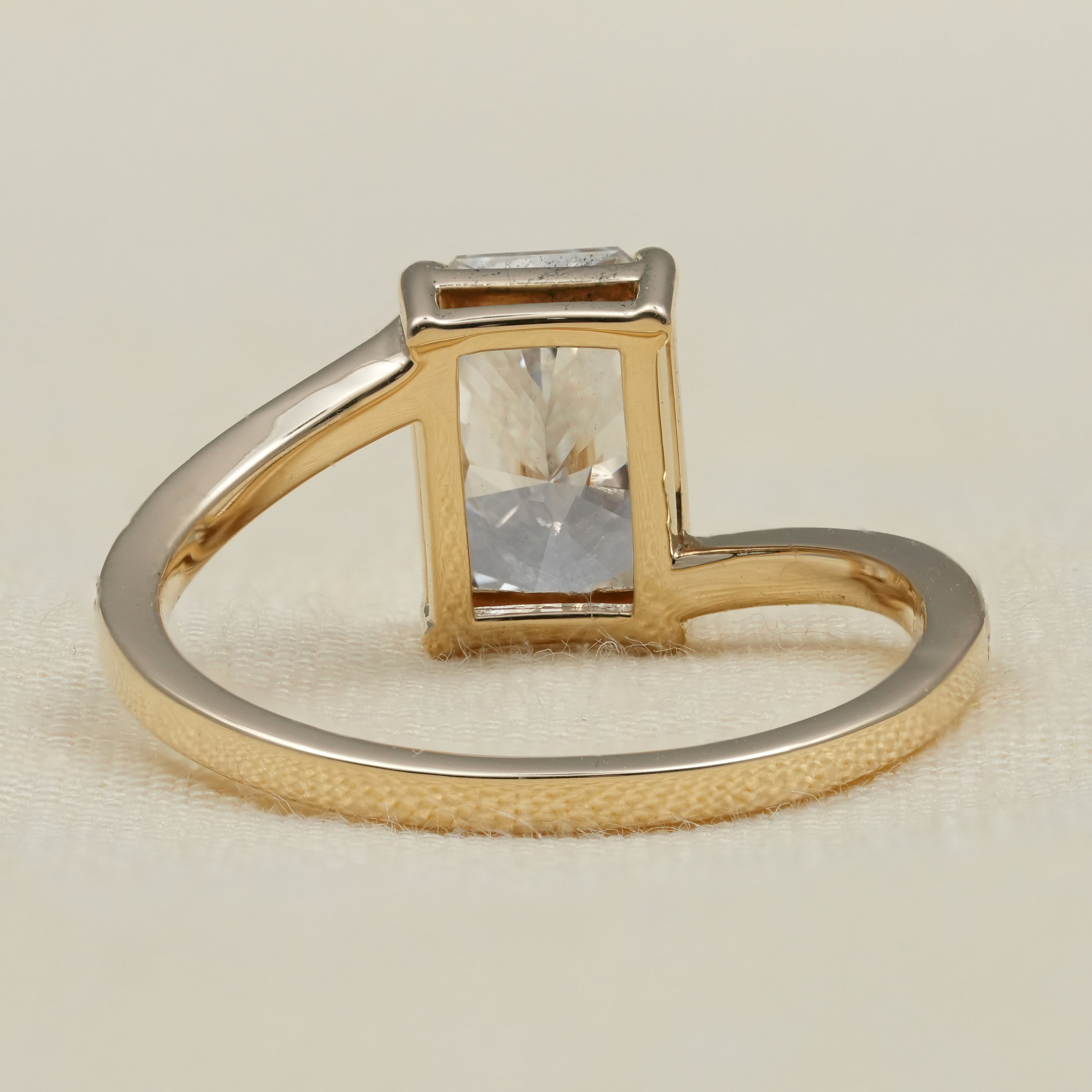 Radiant cut solitaire showcasing lab grown diamond bypass band design