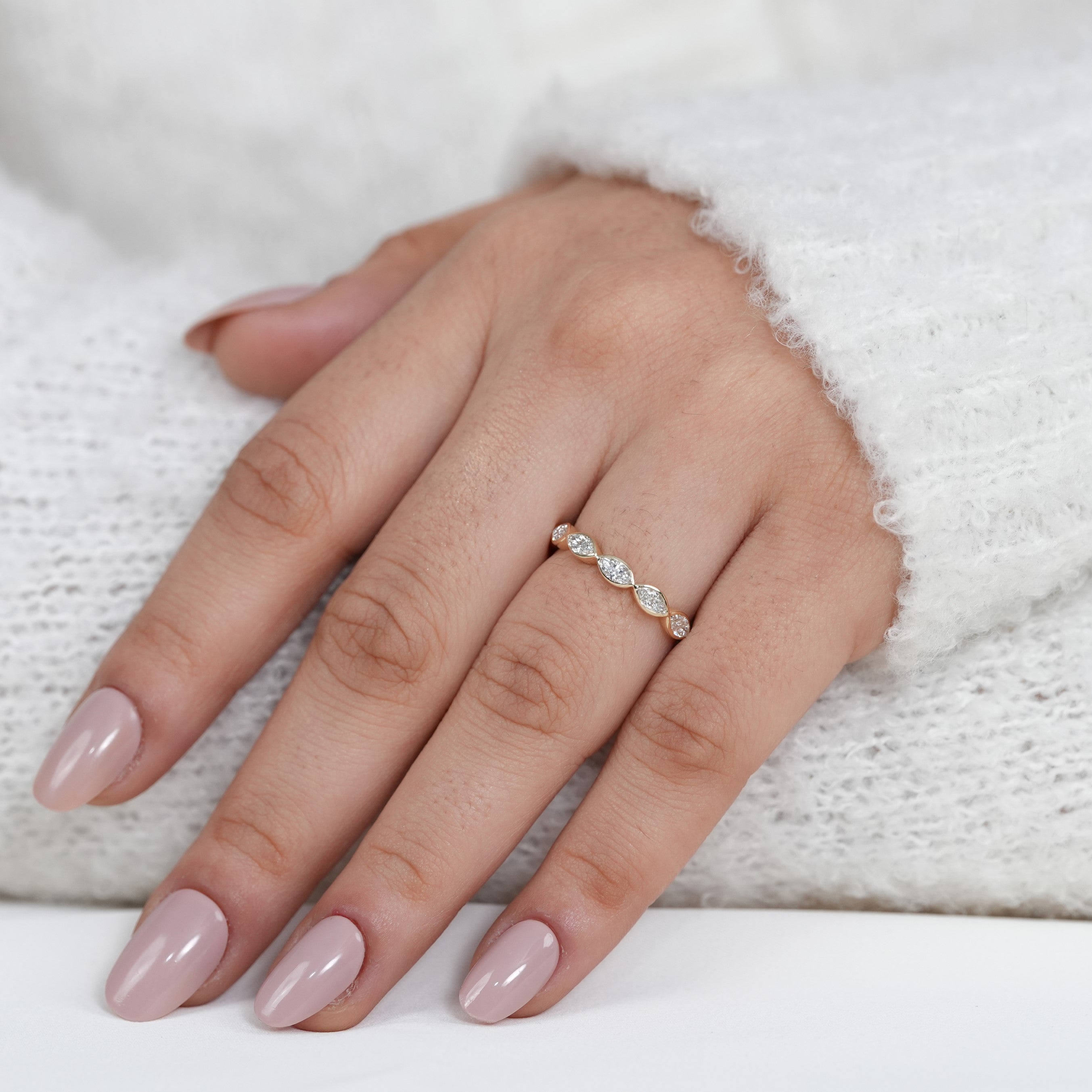 Delicate bezel set marquise diamond band showcasing lab grown diamonds