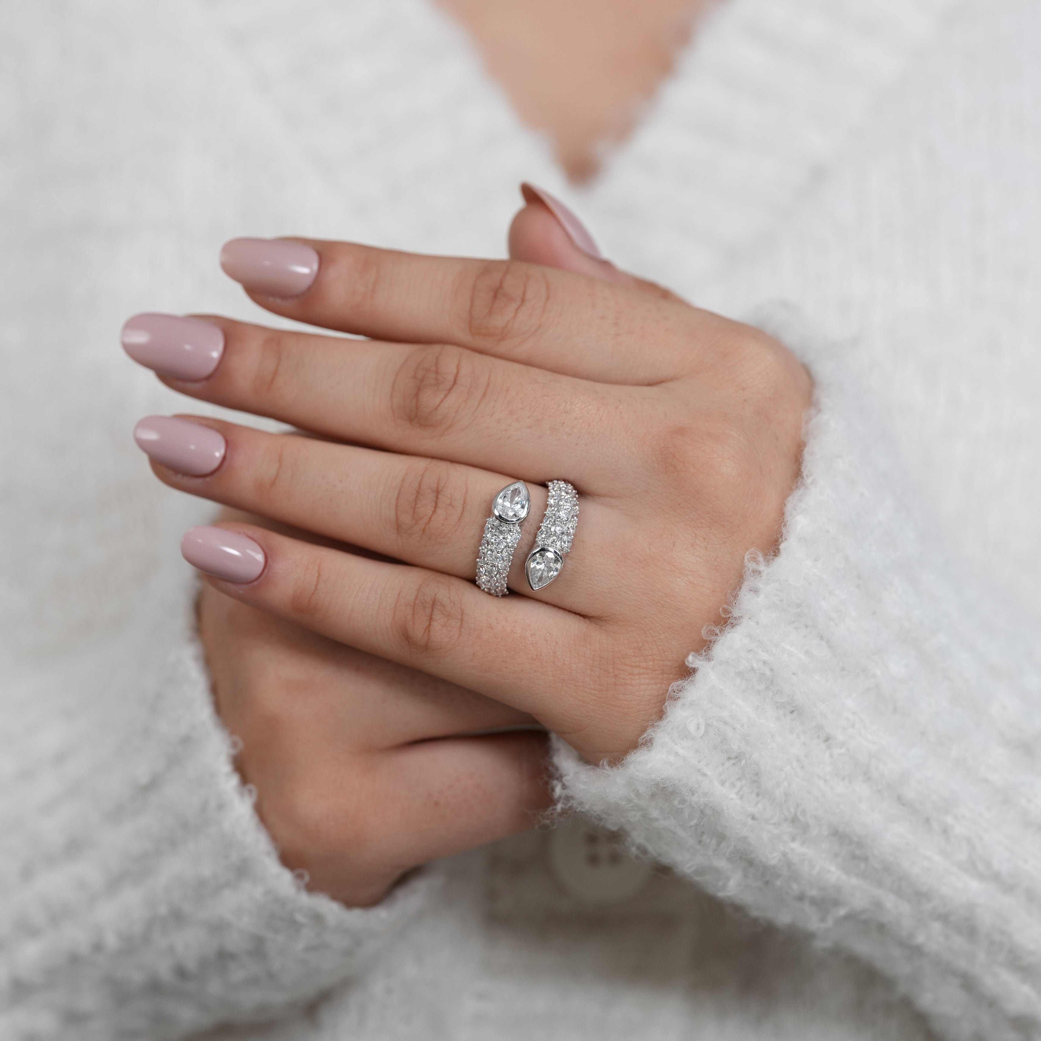 Open bypass ring featuring pear lab grown diamonds with pavé accents