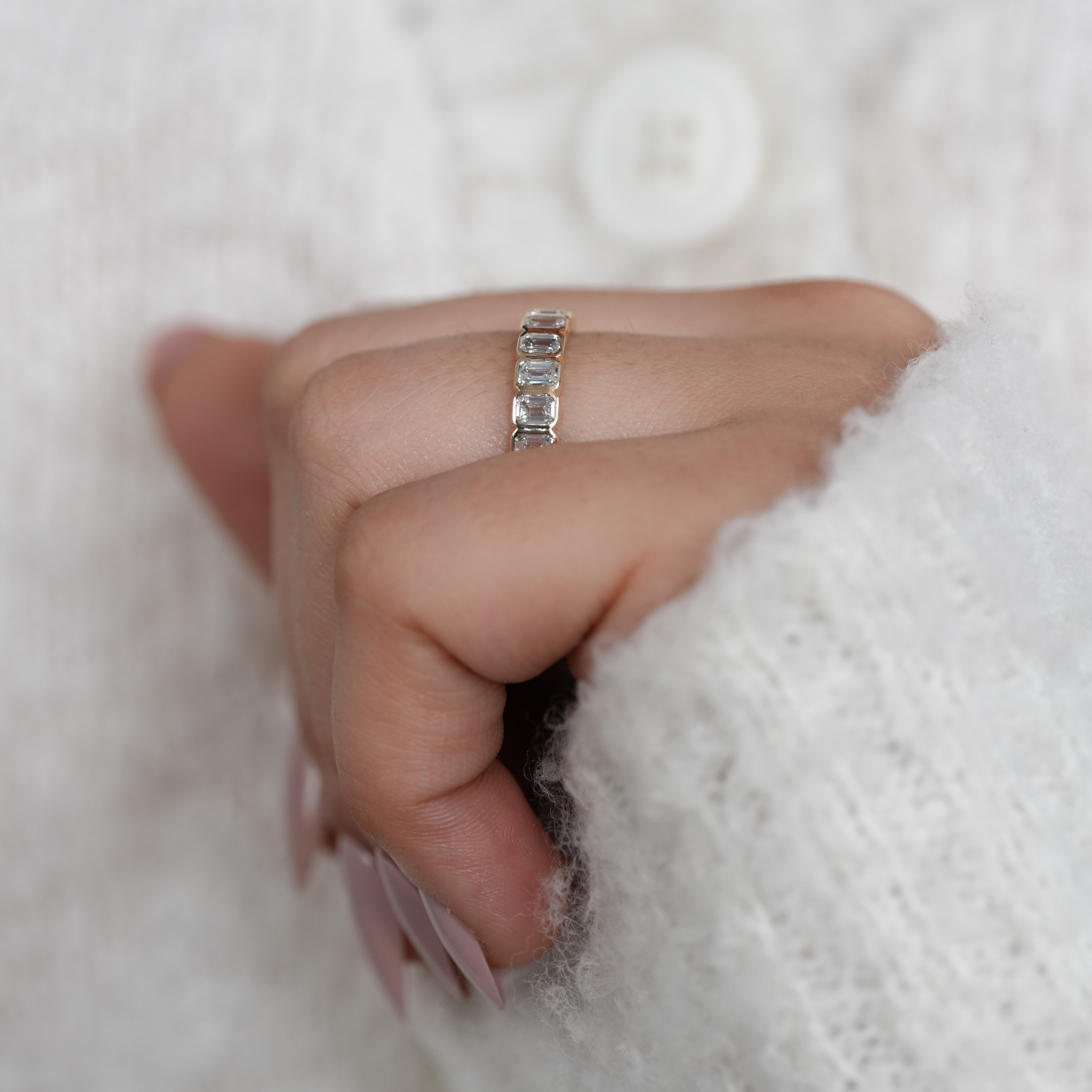 Emerald cut bezel set eternity ring with lab grown diamonds elegant design
