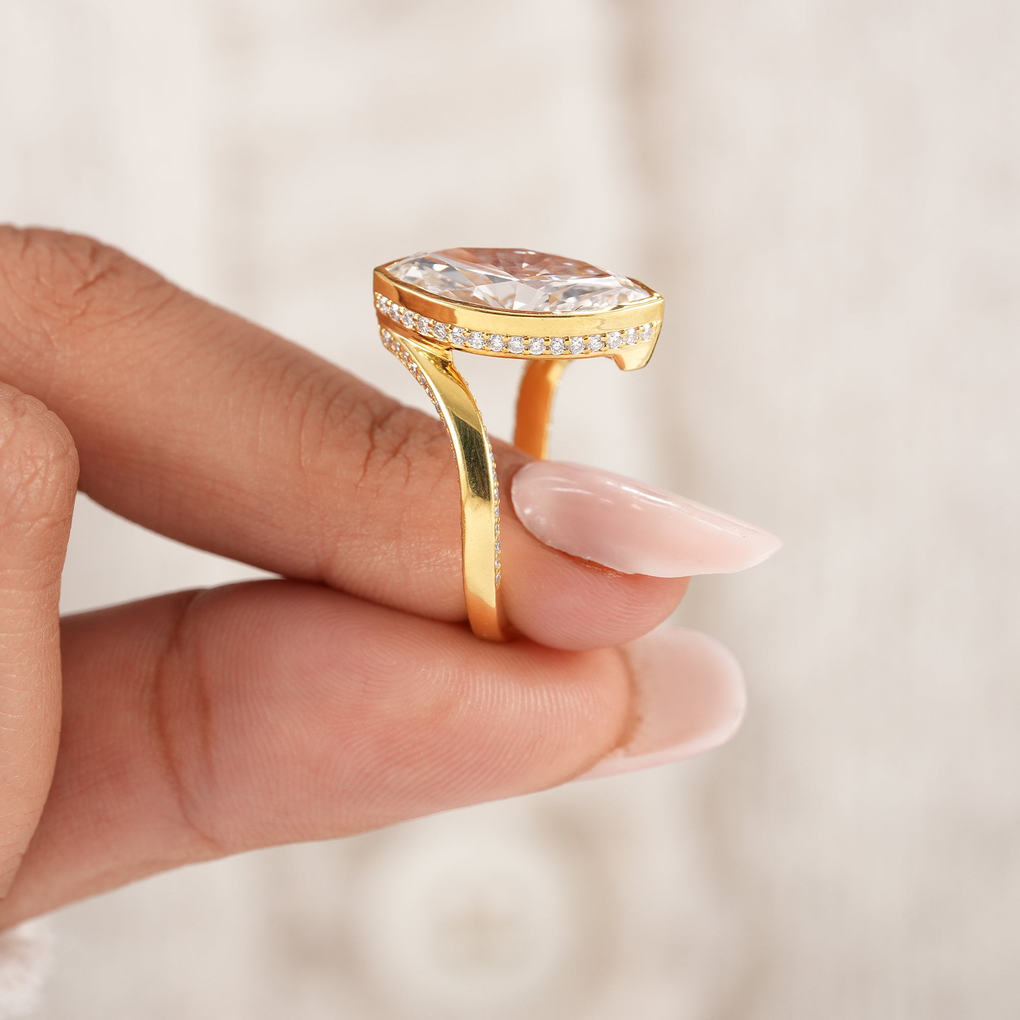 Marquise solitaire ring with pavé diamond bypass shank.