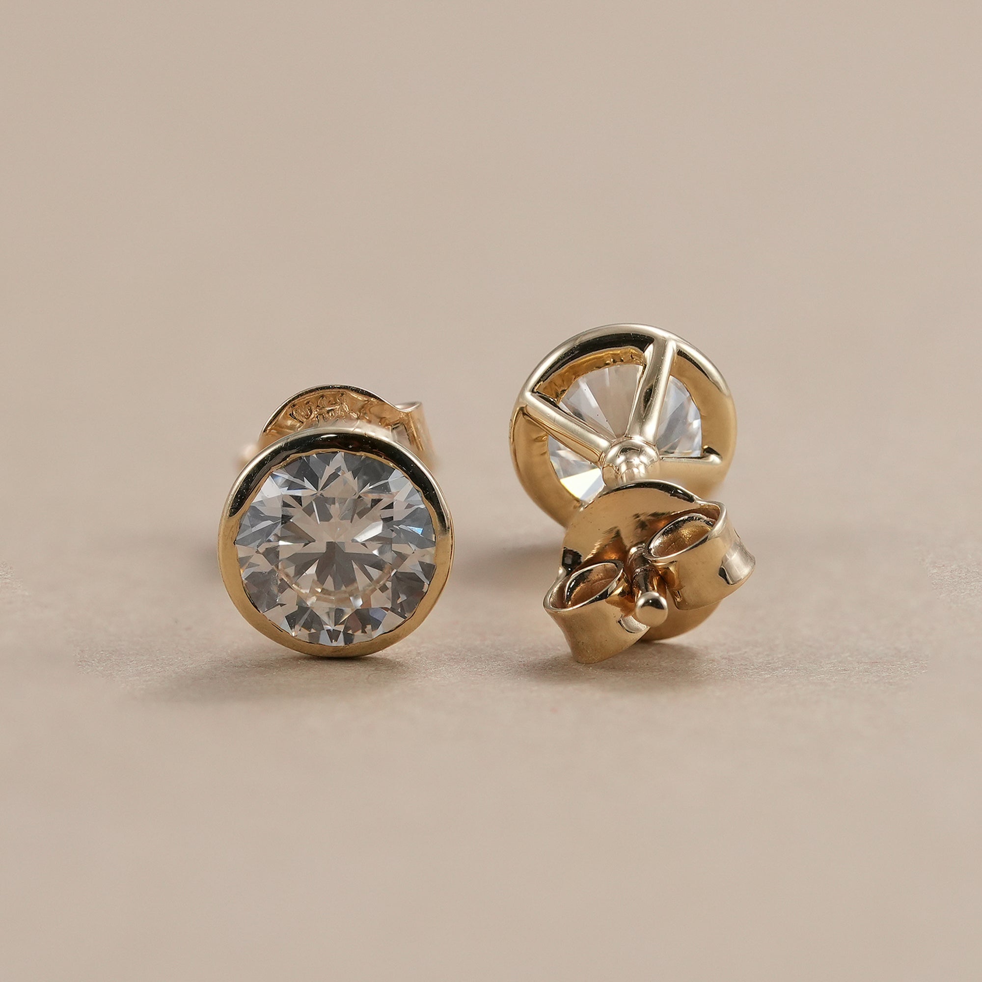 Luxury round diamond stud earrings handcrafted in gold.