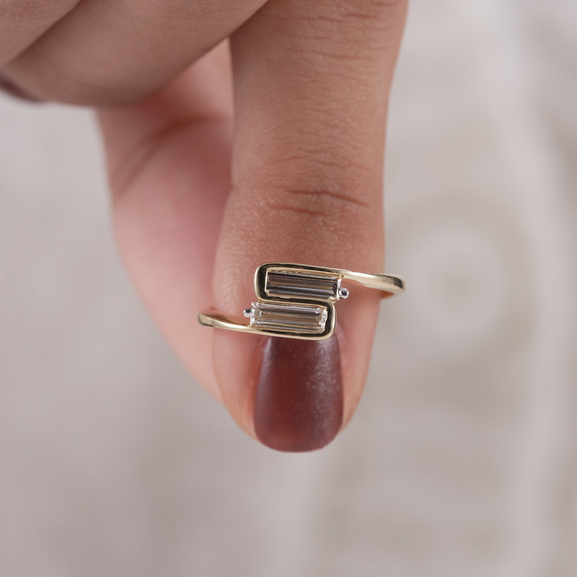 Gold Toi et Moi ring featuring bezel set baguette diamonds