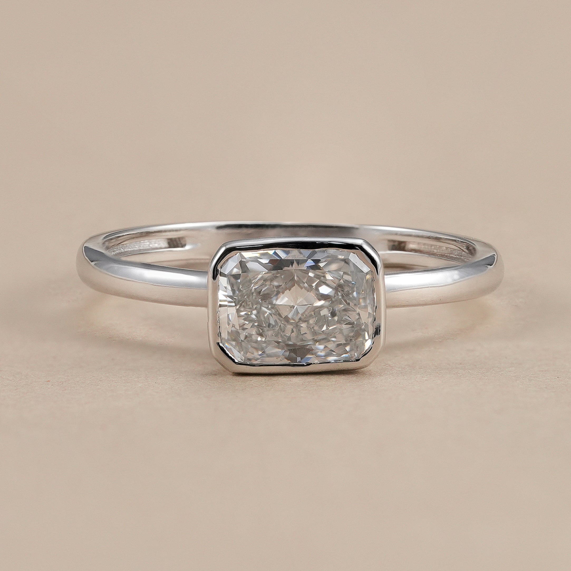 East west radiant cut lab grown diamond ring in secure bezel setting