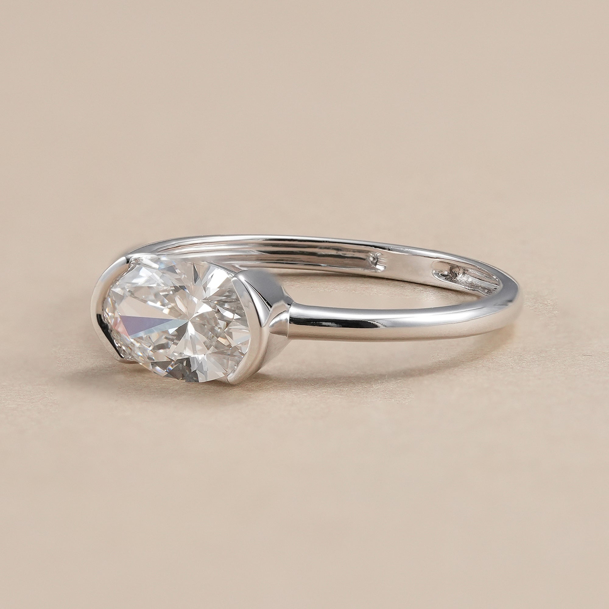 Half bezel set oval lab diamond engagement ring