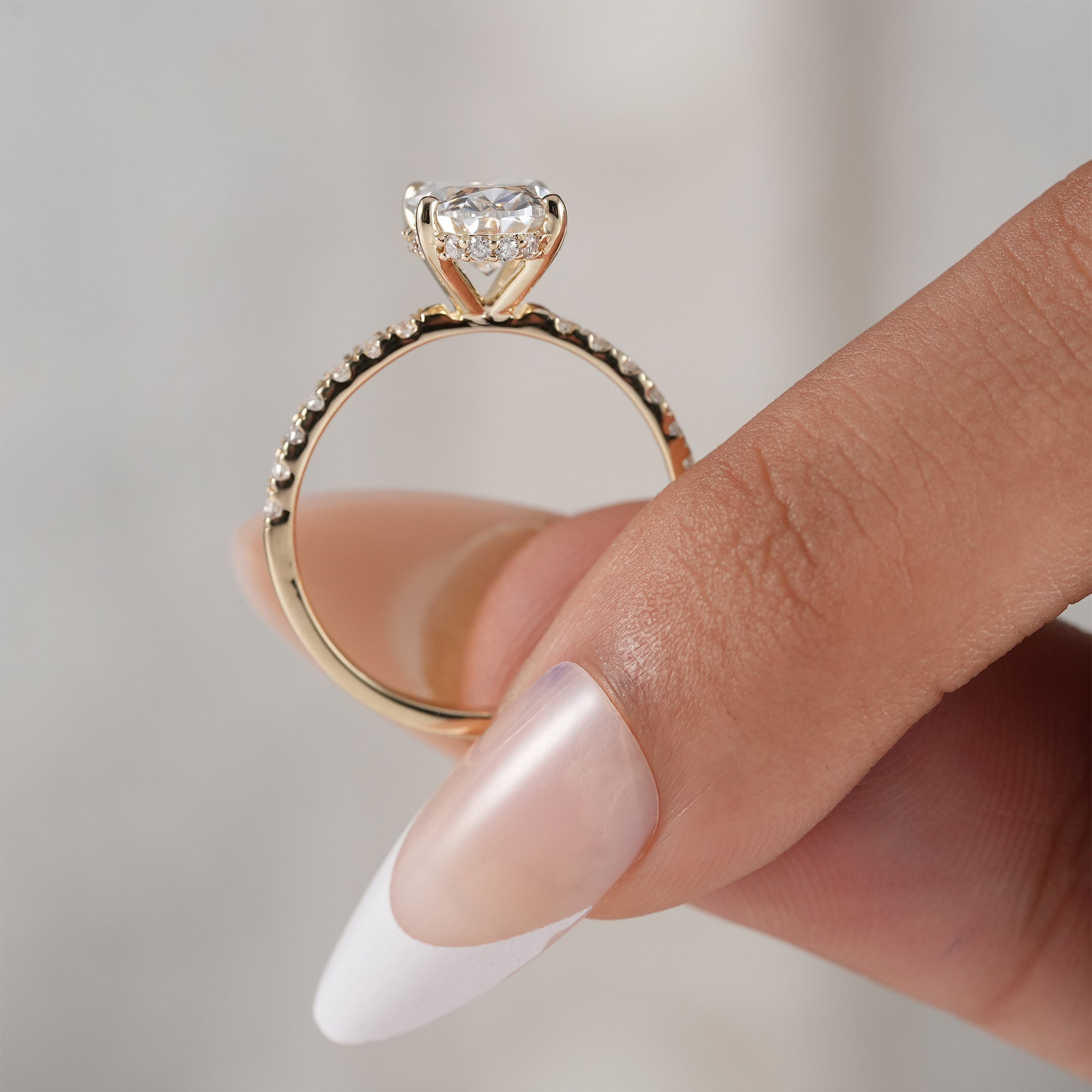 Fine jewelry oval hidden halo bridal ring.
