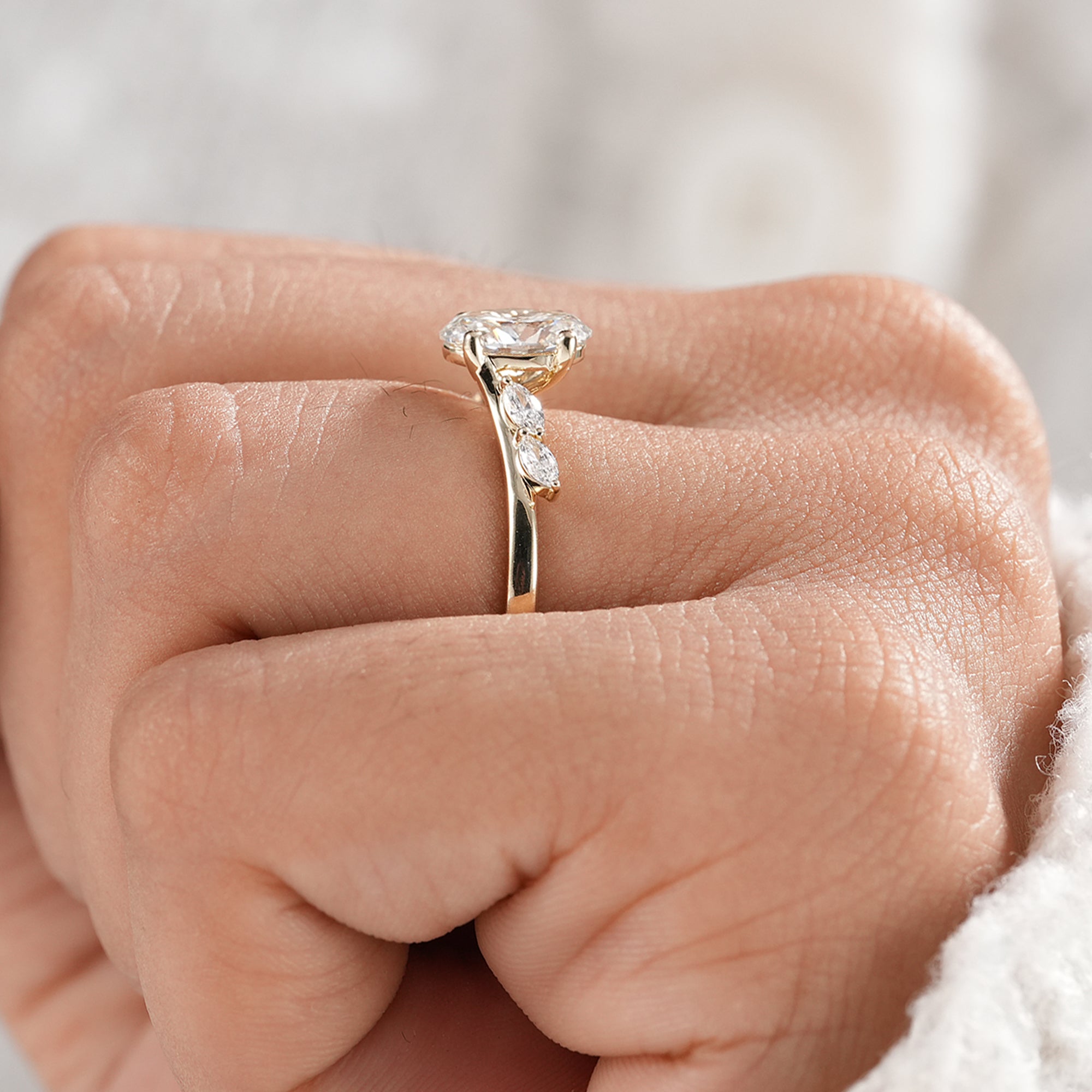 Fine jewelry oval engagement ring with marquise side stones.