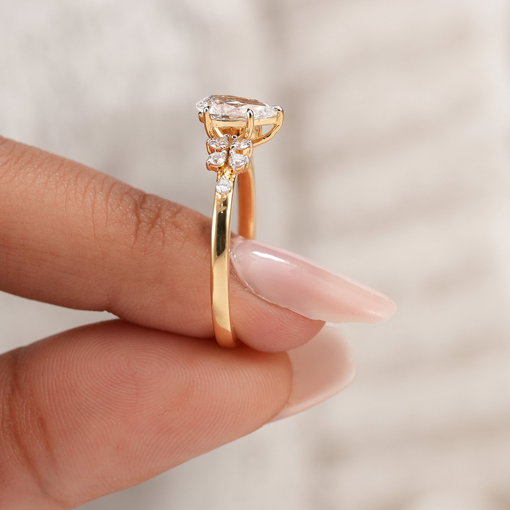 Women's pear diamond ring with round accent stone setting
