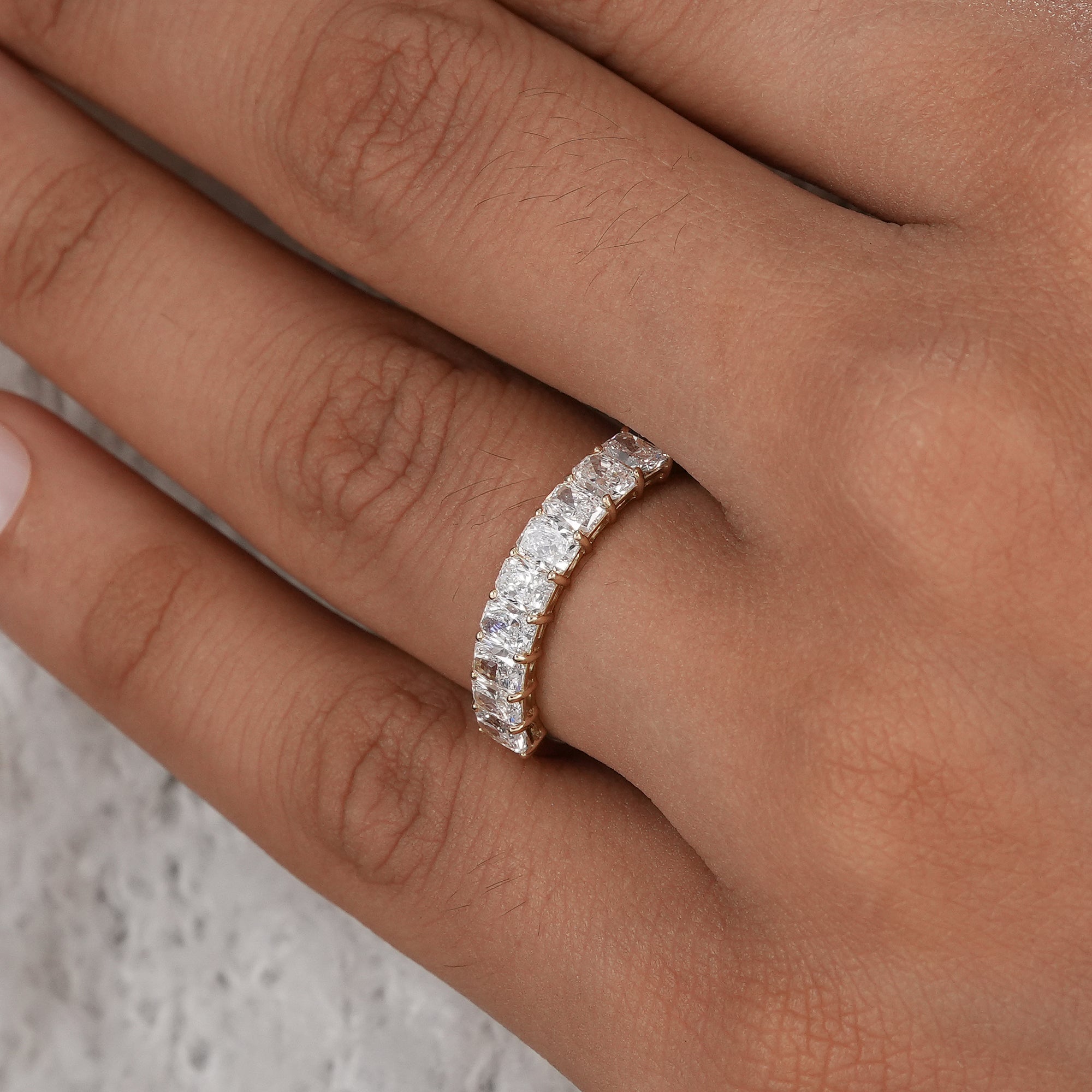Minimalist radiant wedding band with shared prongs.