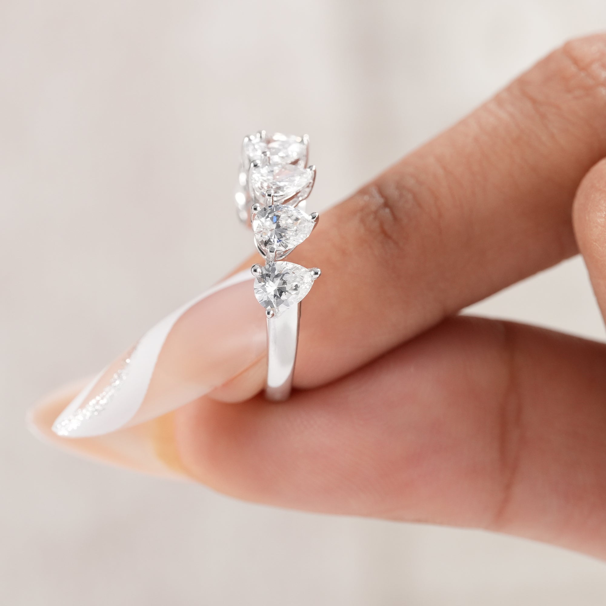 Classic pear diamond wedding band with elegant shared prongs.