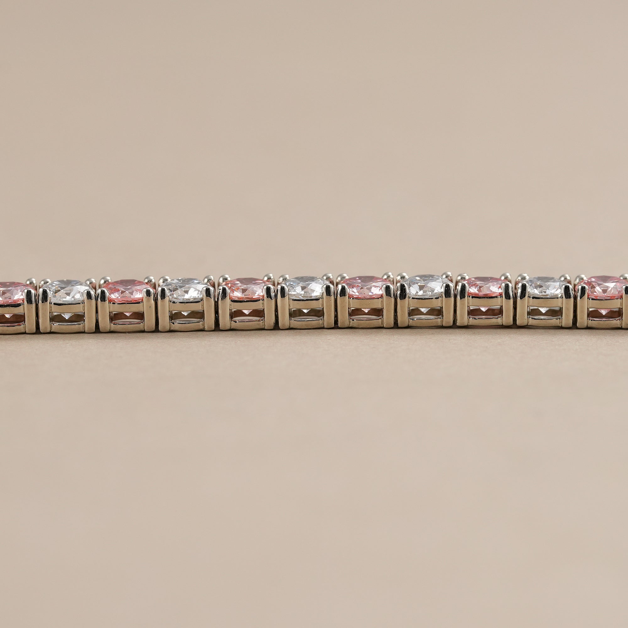 Sustainable lab grown diamond bracelet with alternating pink and white stones.