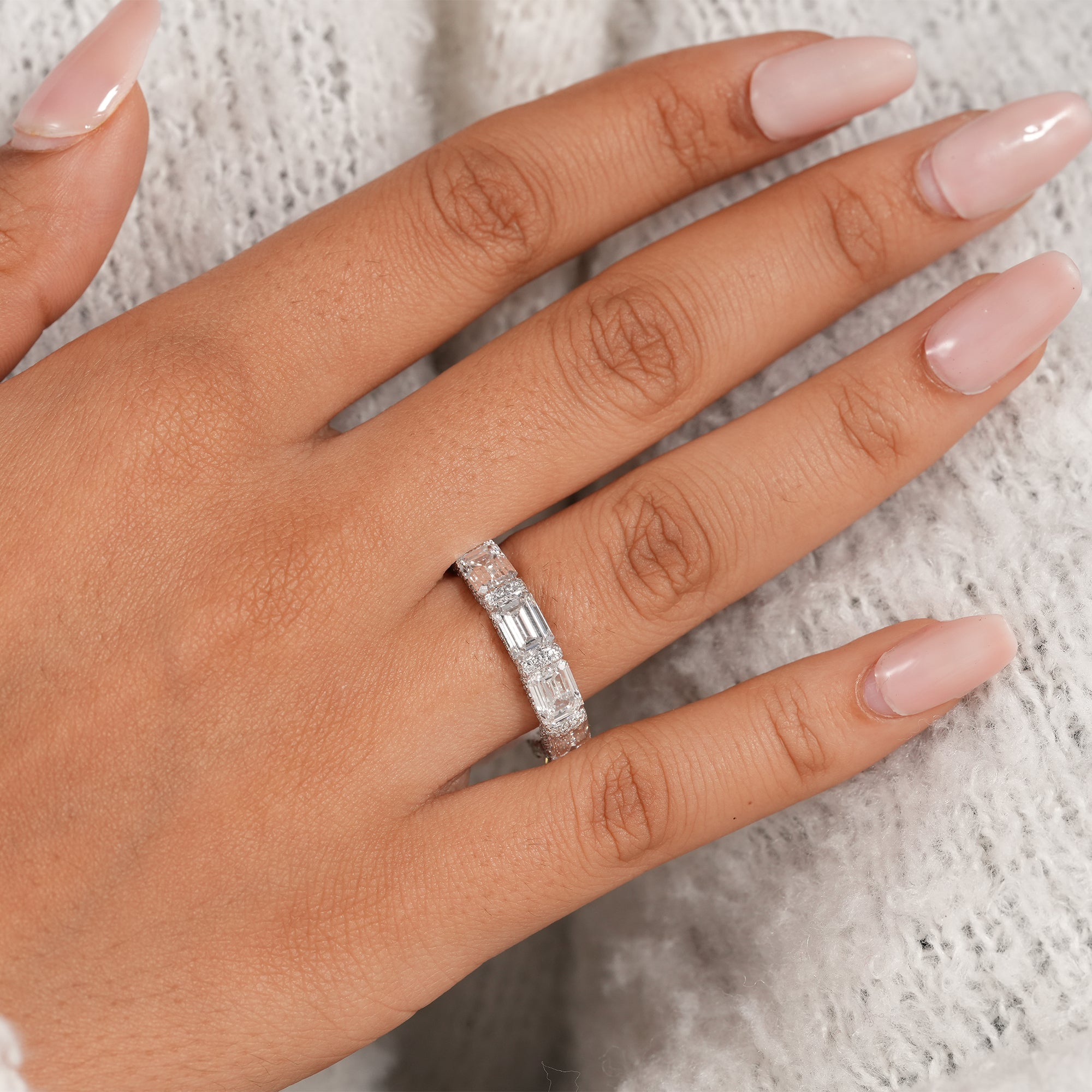 Luxury emerald cut stackable wedding band in white gold.
