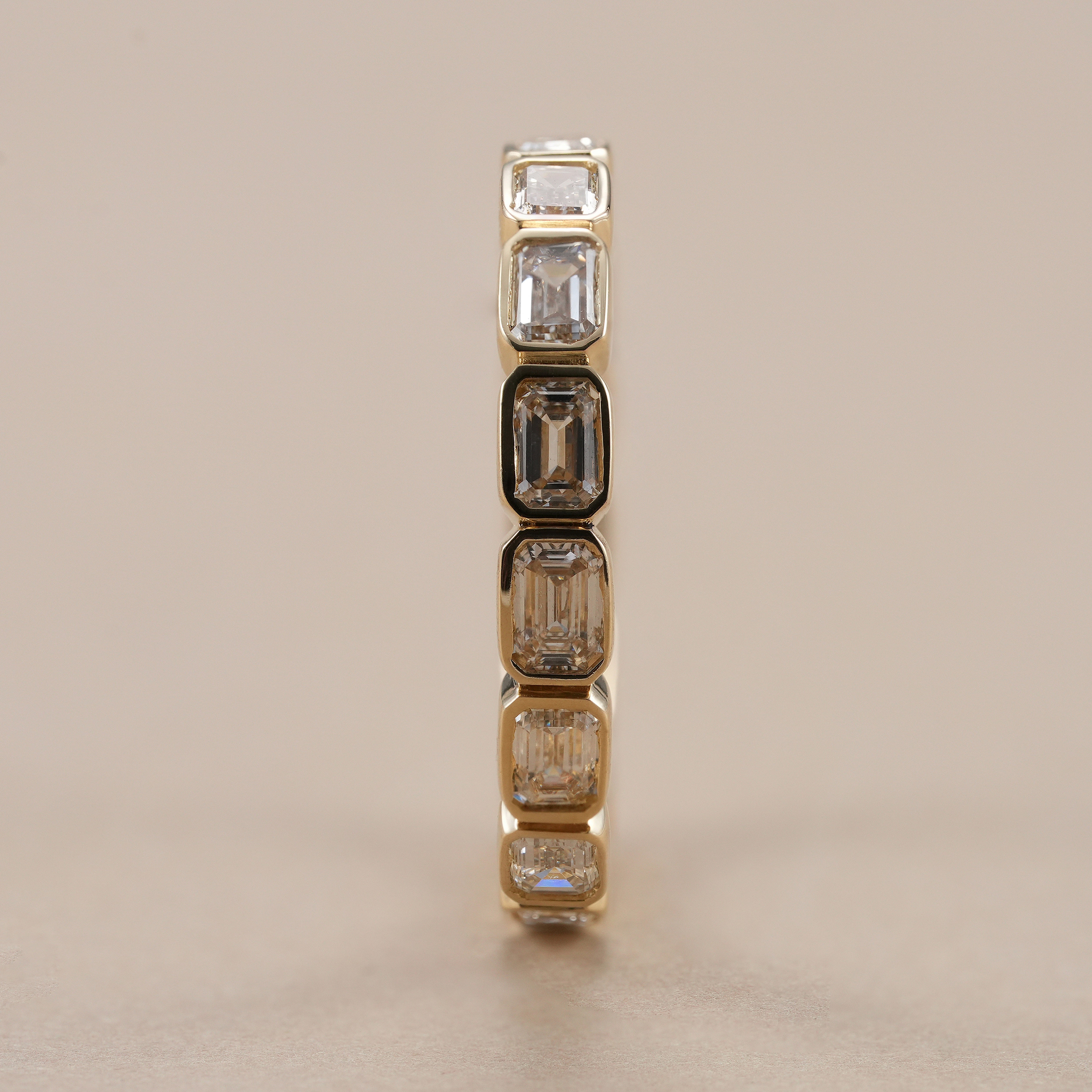 Full eternity band featuring emerald cut lab grown diamonds.