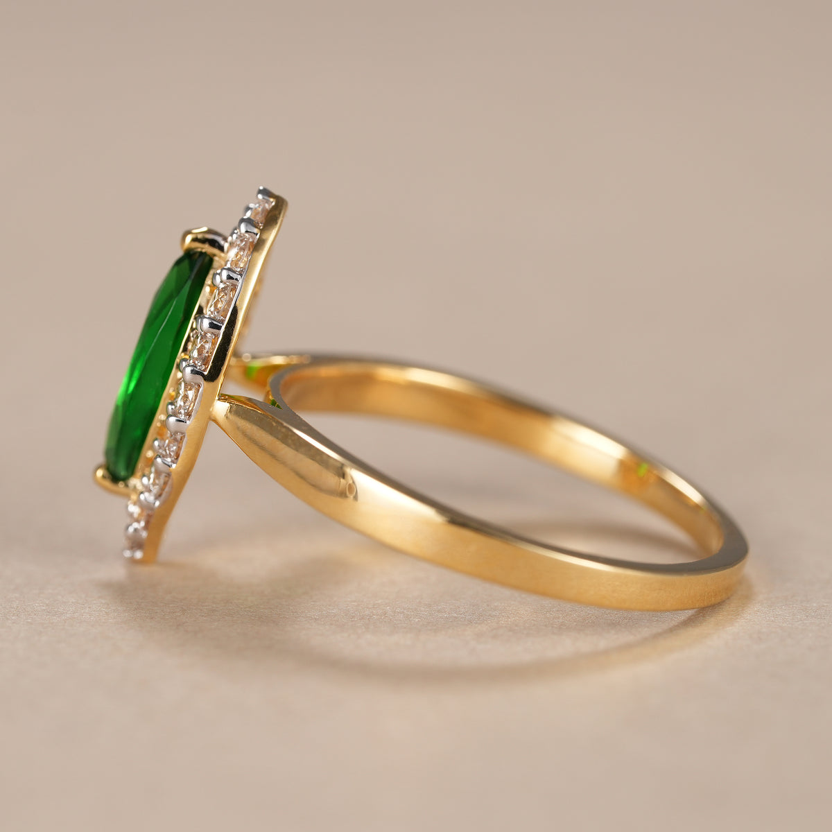 Luxury marquise emerald engagement ring handcrafted with ethical lab grown diamond halo.