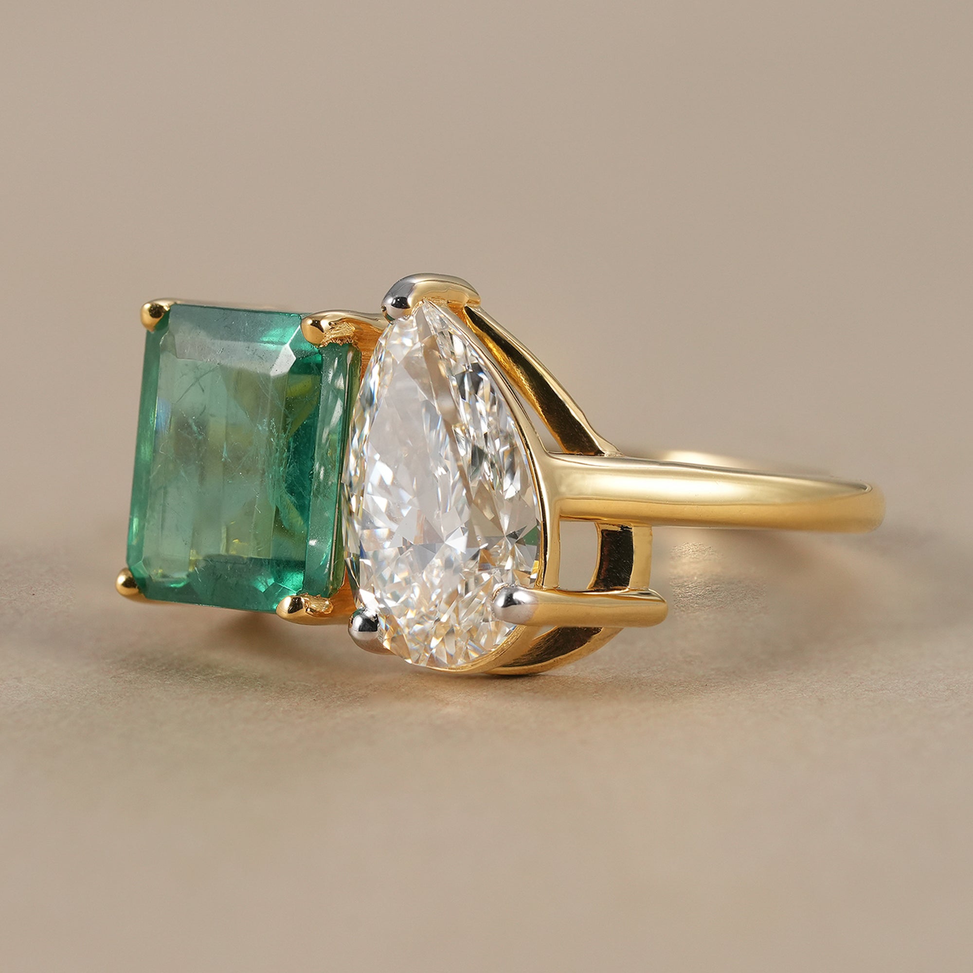 Women's two stone emerald and pear diamond wedding ring