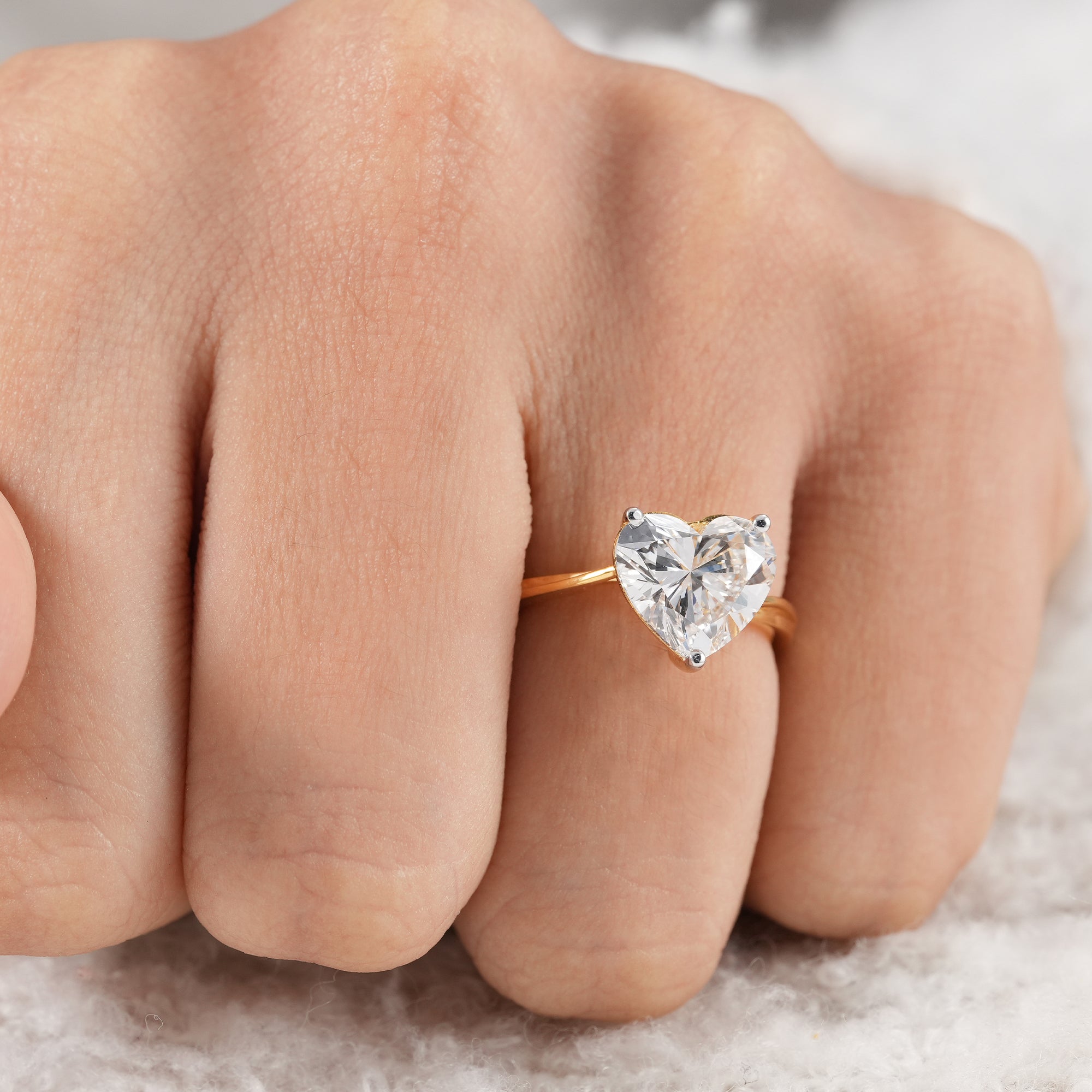 Luxury heart cut diamond ring with polished gold band.