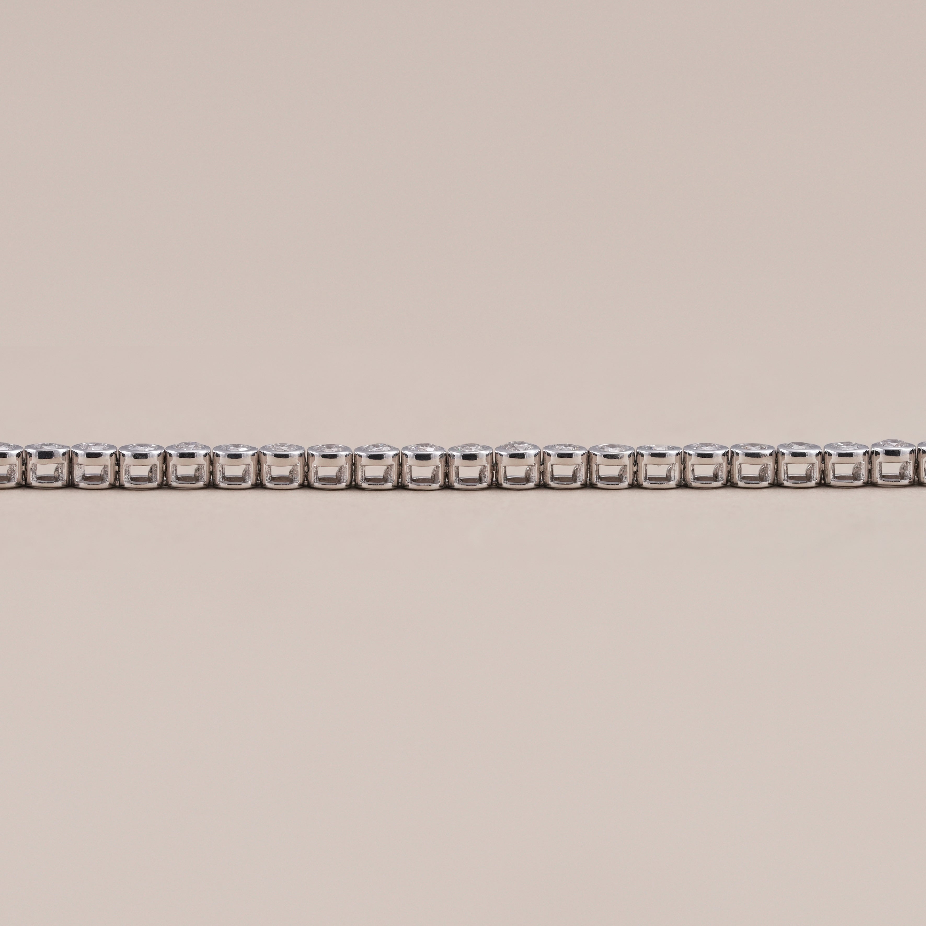 Minimalist lab grown diamond tennis bracelet with secure bezel design.