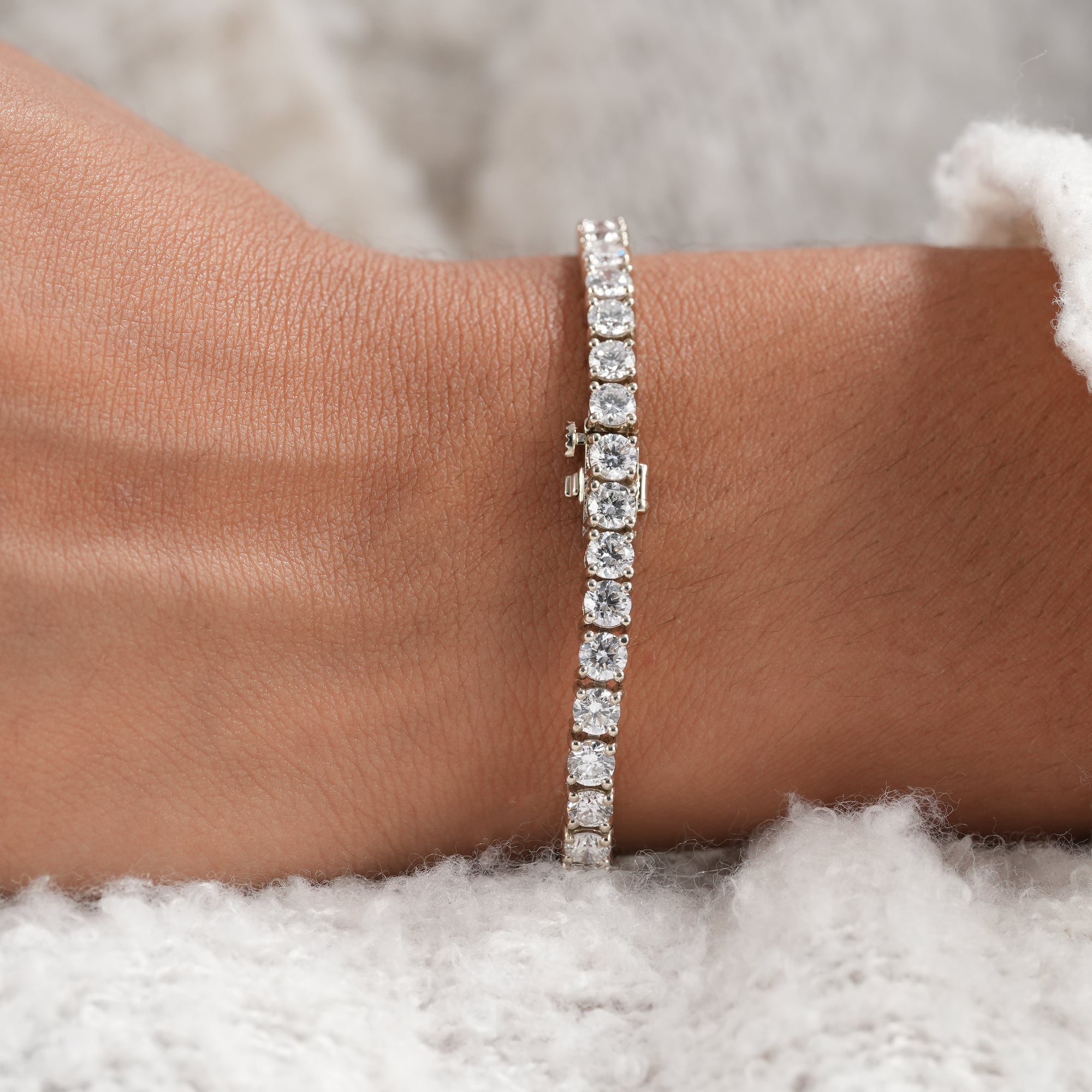 Timeless round diamond tennis bracelet handcrafted in precious metal.