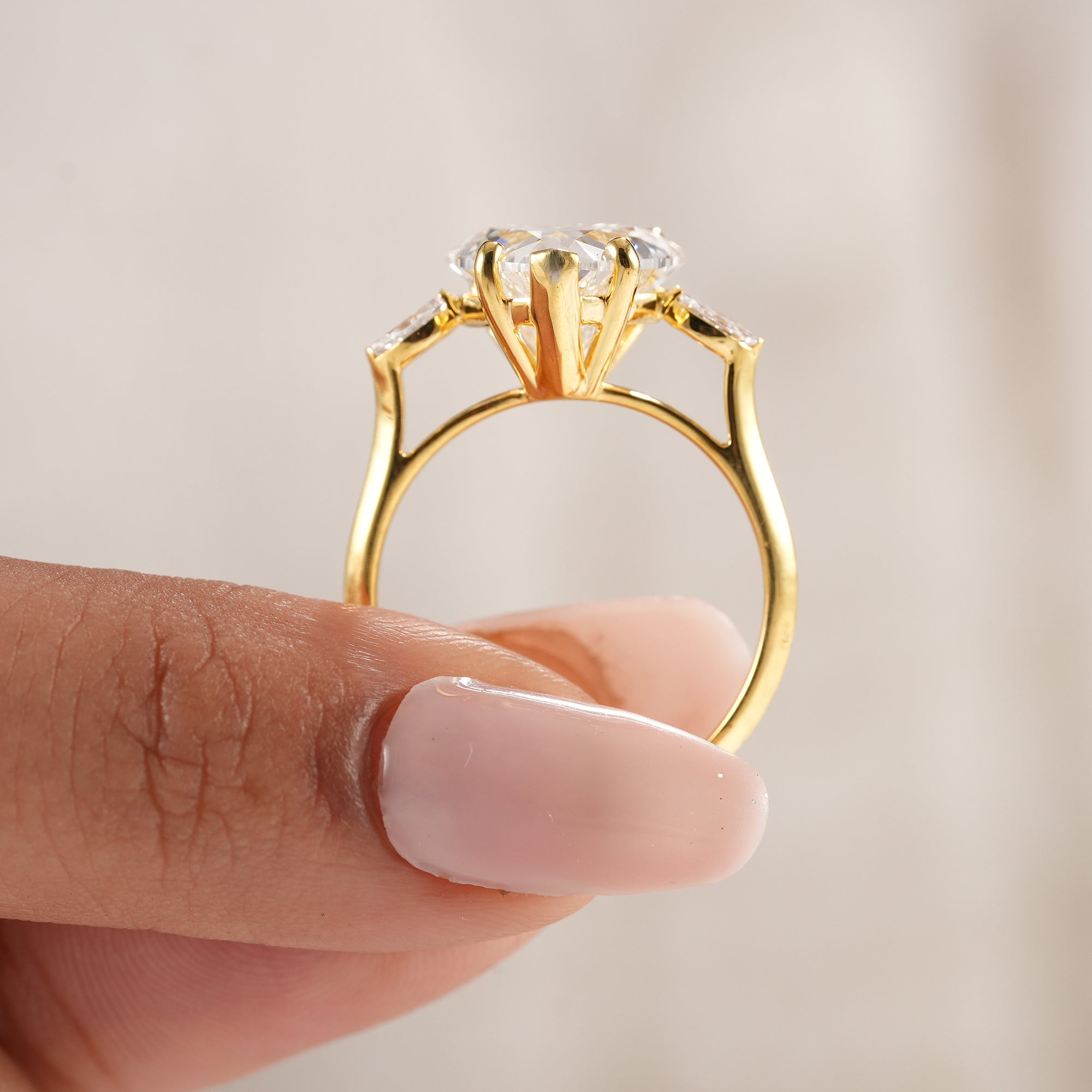 Sustainable lab grown heart engagement ring with pear diamonds.