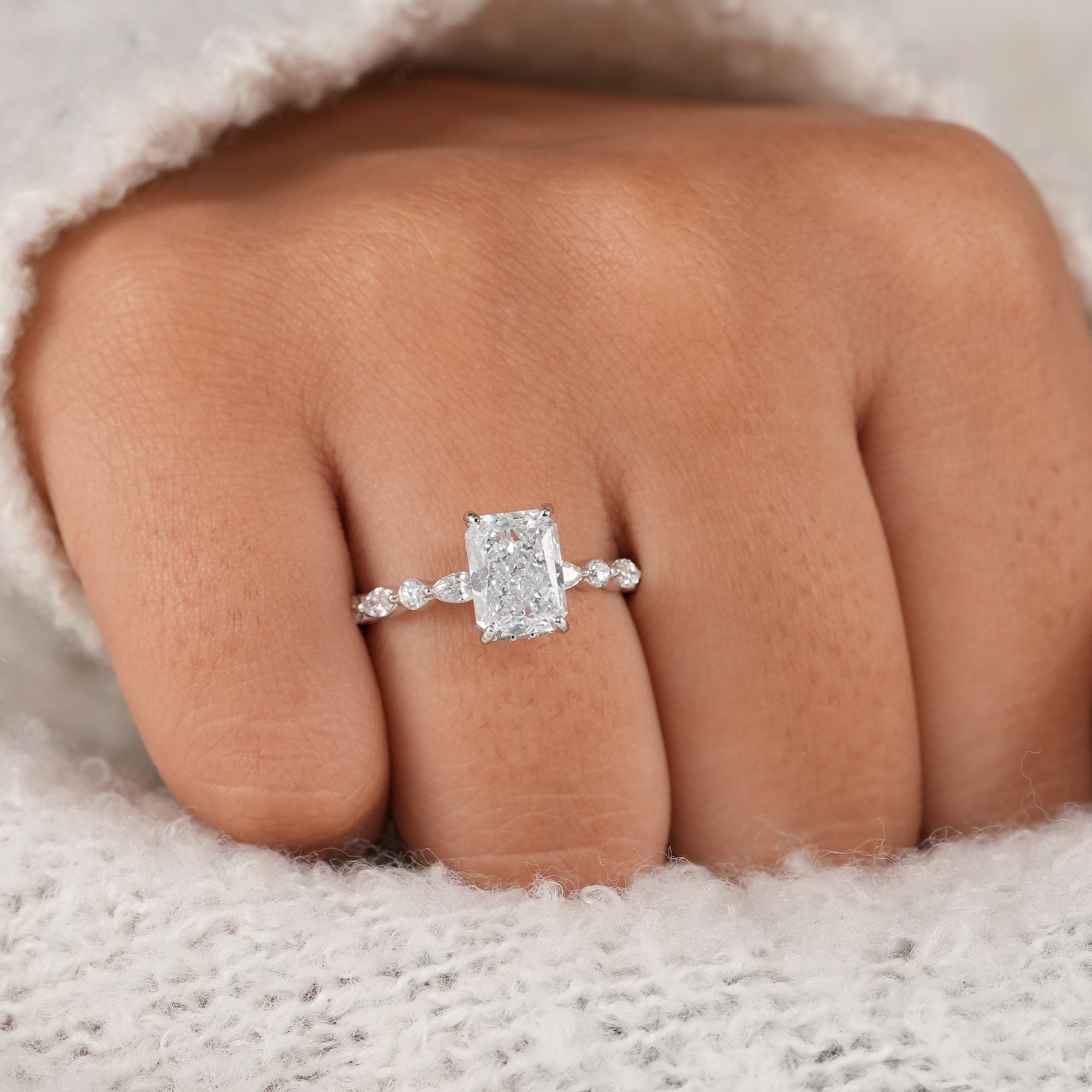 Close-up of radiant lab grown diamond engagement ring.