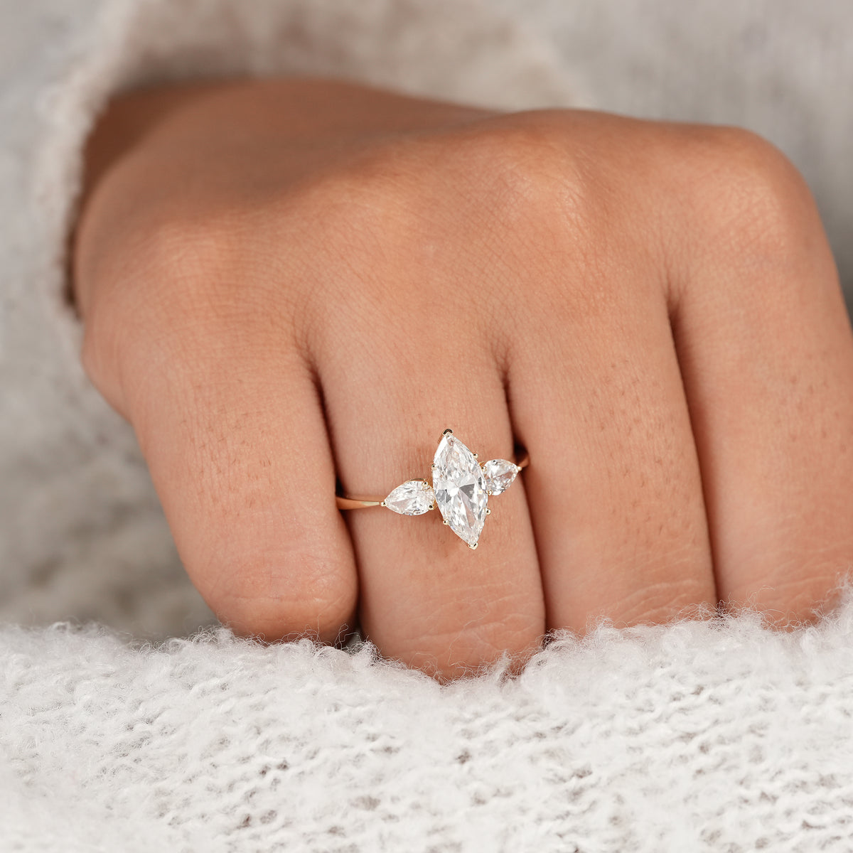 Elegant marquise bridal ring with pear side stones for weddings and special occasions.