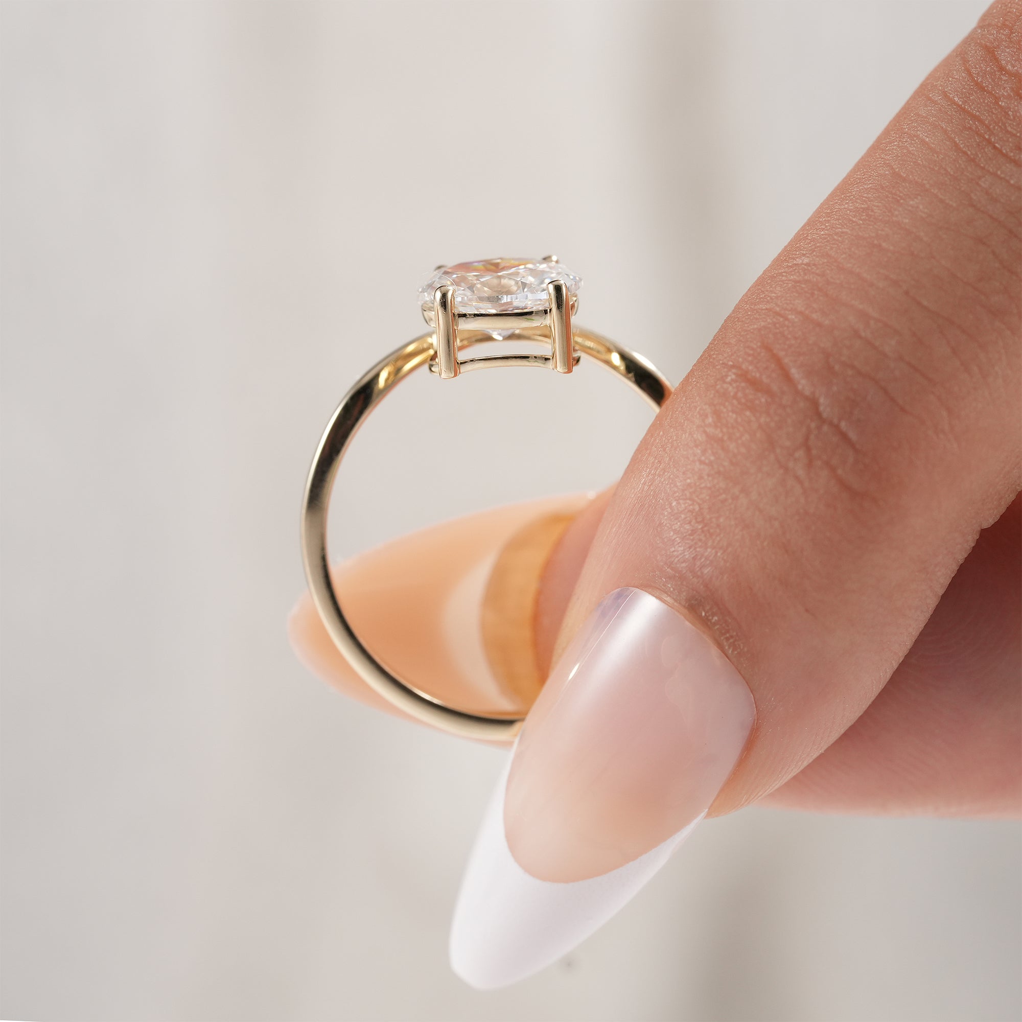 Oval diamond ring with elegant V shaped band.