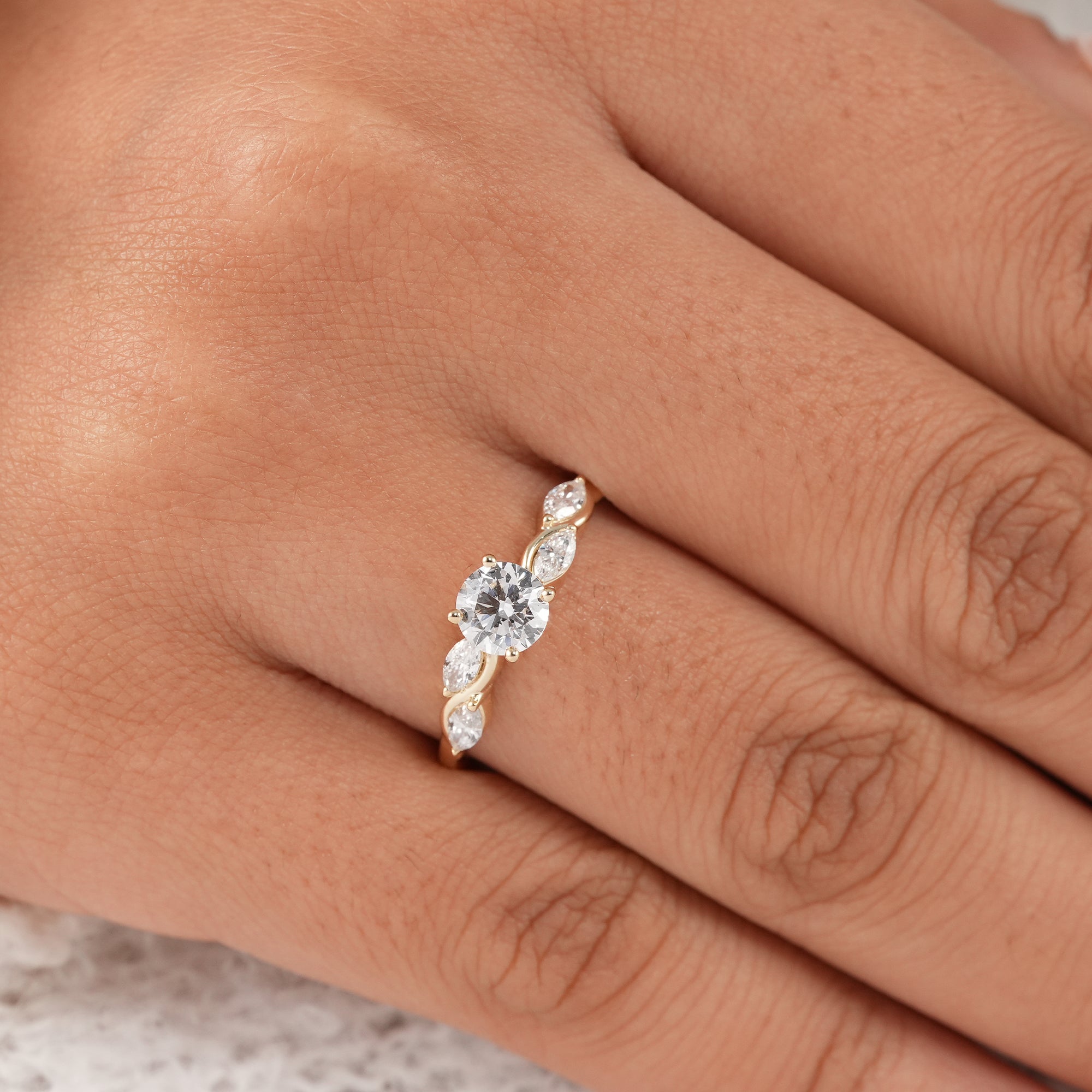 Fine jewelry engagement ring with marquise side stones.