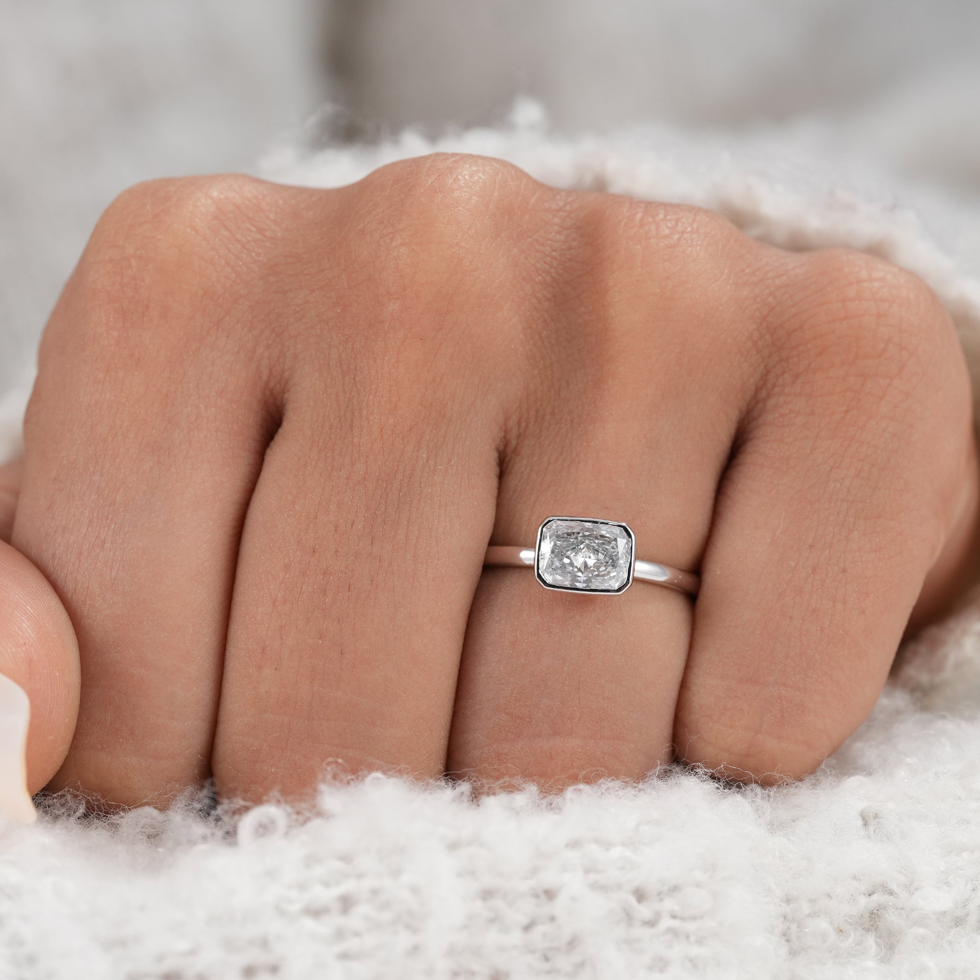 Horizontal radiant diamond solitaire ring in polished white gold