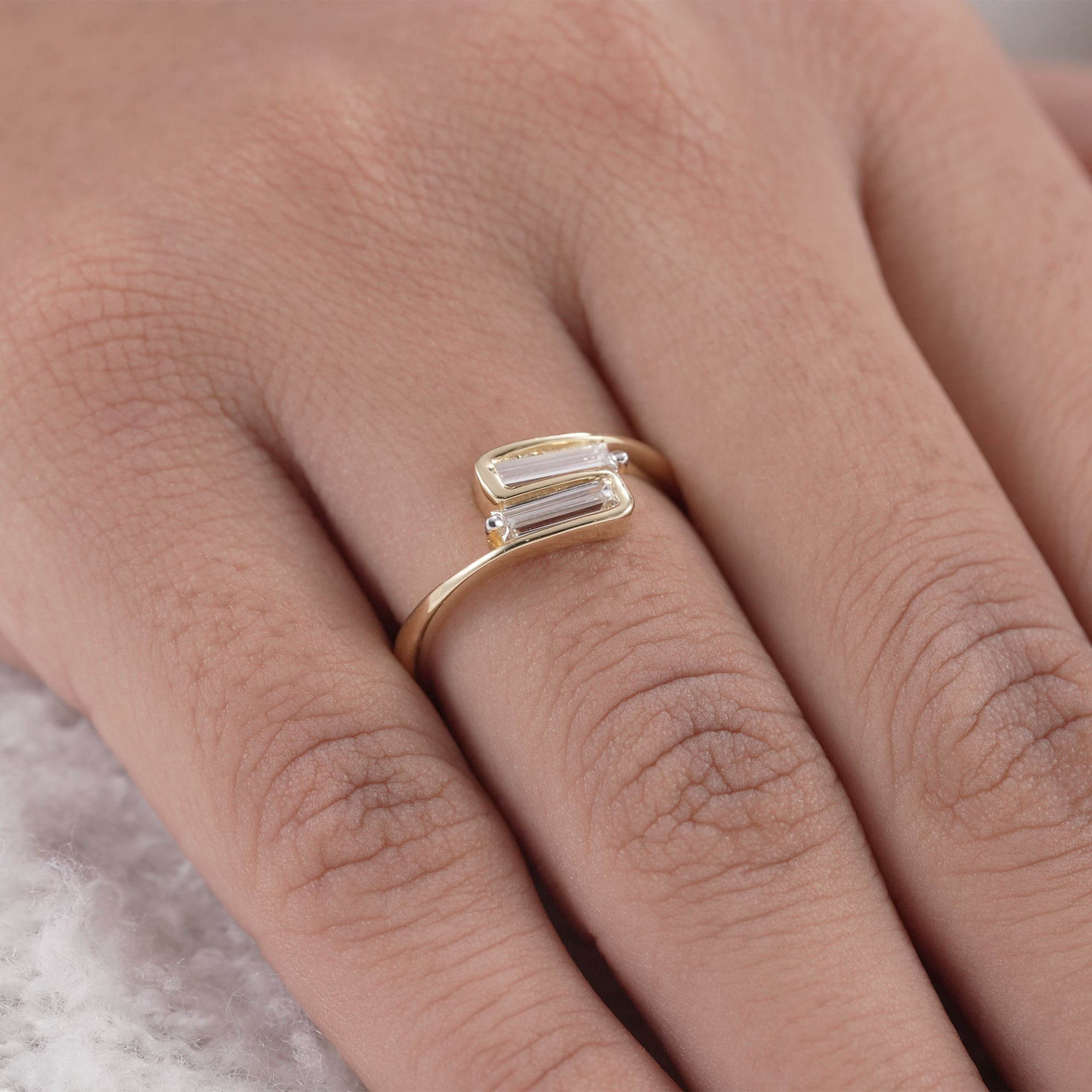 Fine jewelry baguette diamond bypass ring in yellow gold
