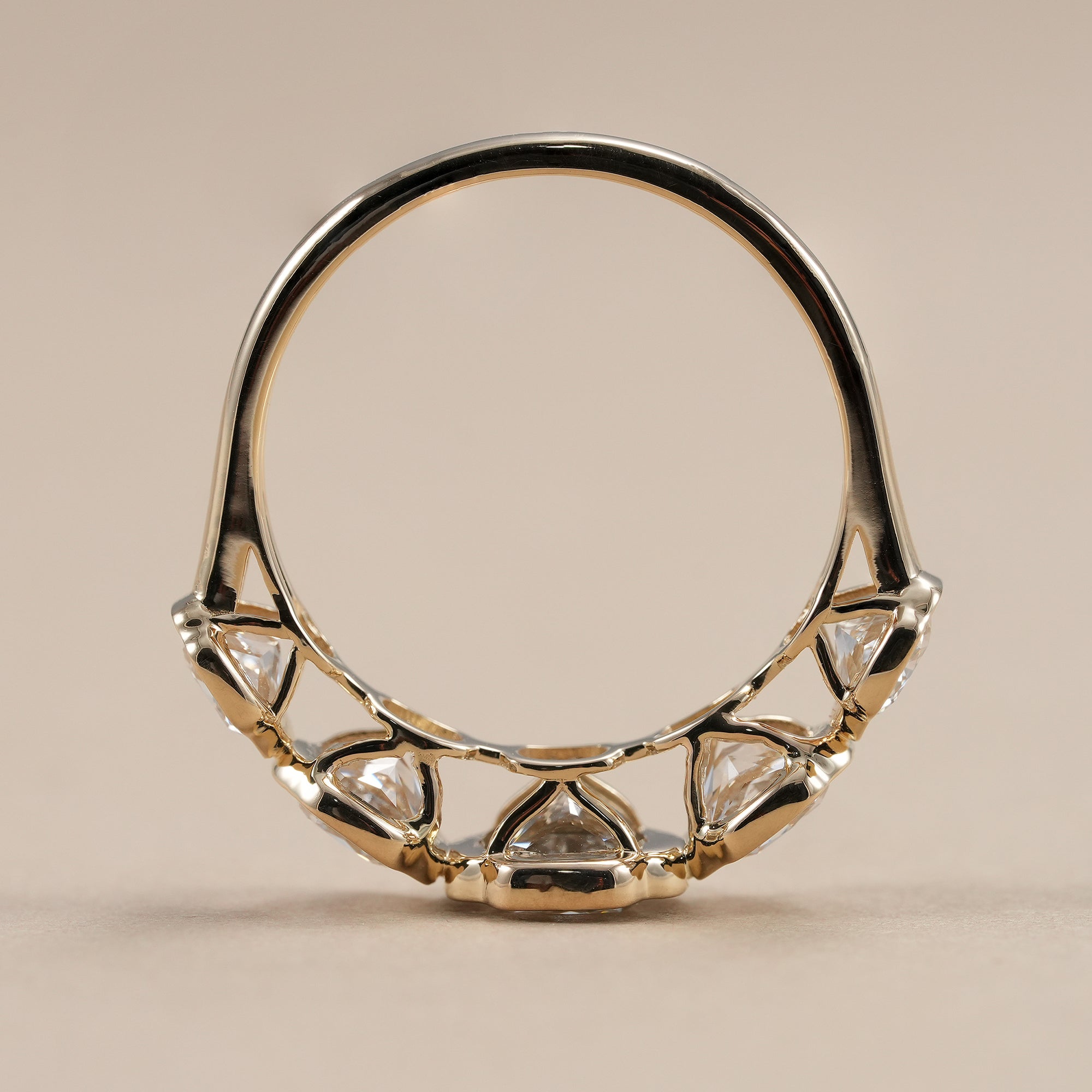 Five stone lab grown diamond anniversary ring with bezel setting.