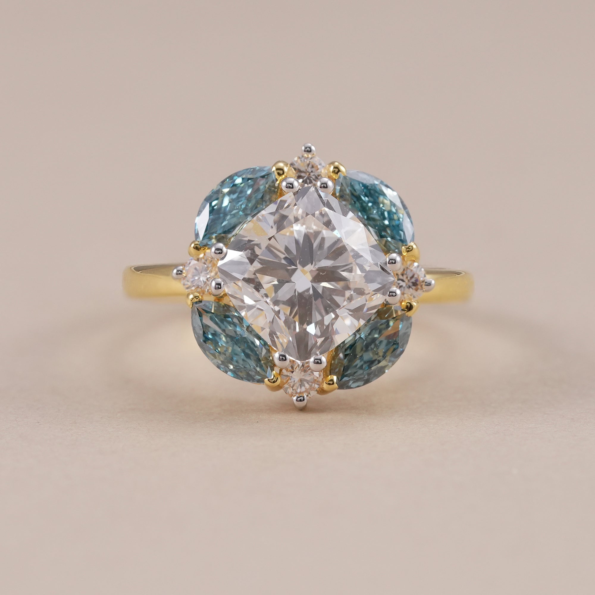 Floral cluster engagement ring featuring cushion diamond center stone