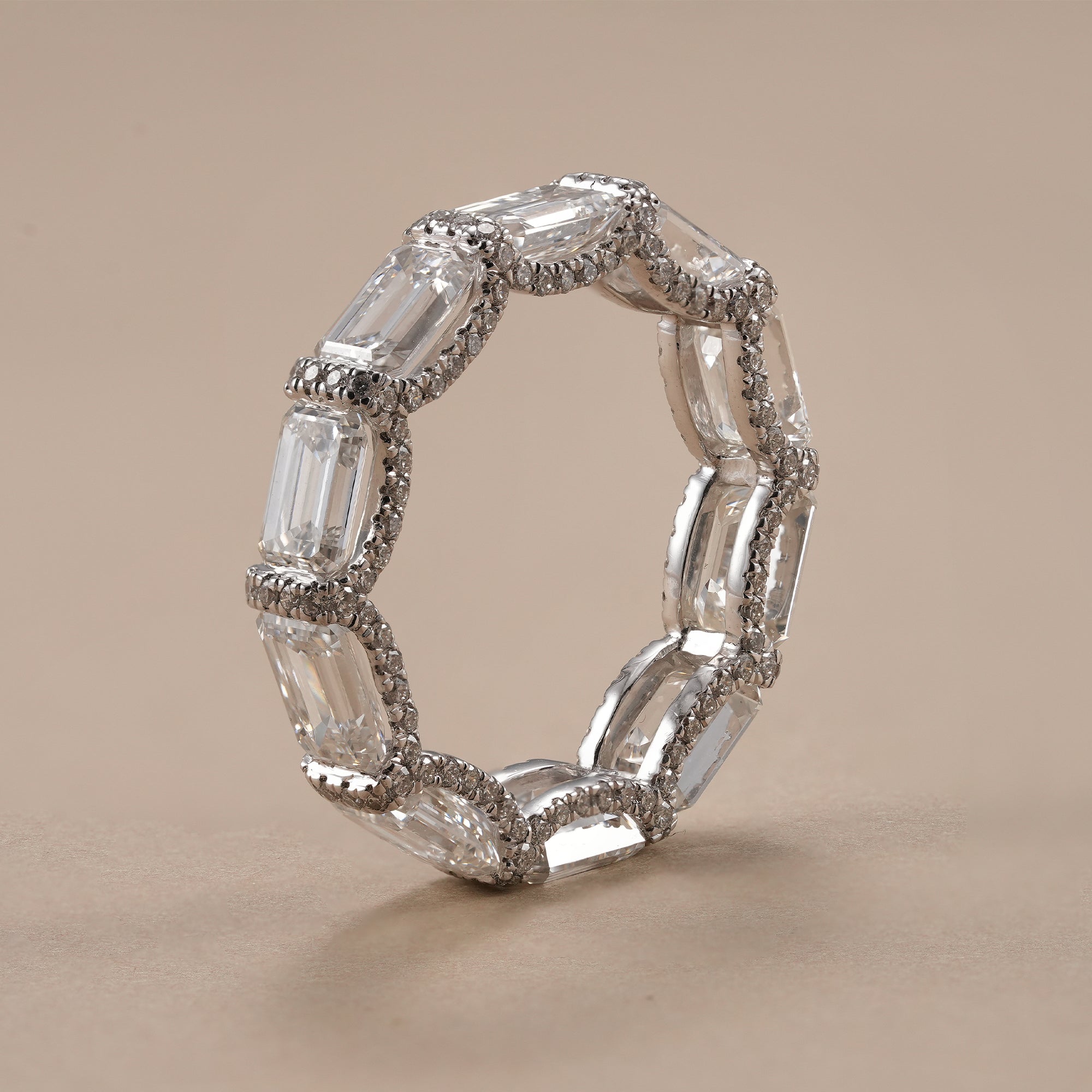 Full eternity wedding band featuring emerald cut lab diamonds.