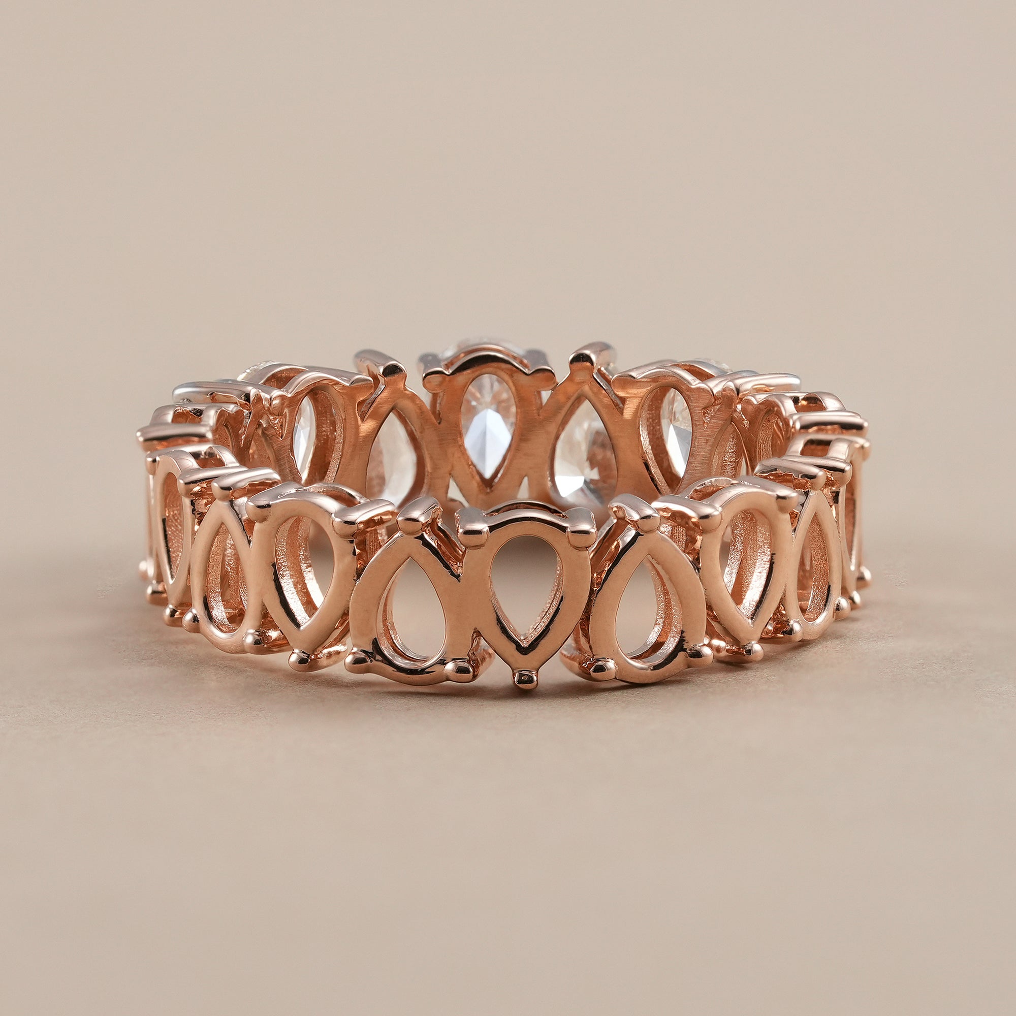 Rose gold pear diamond bridal eternity band.