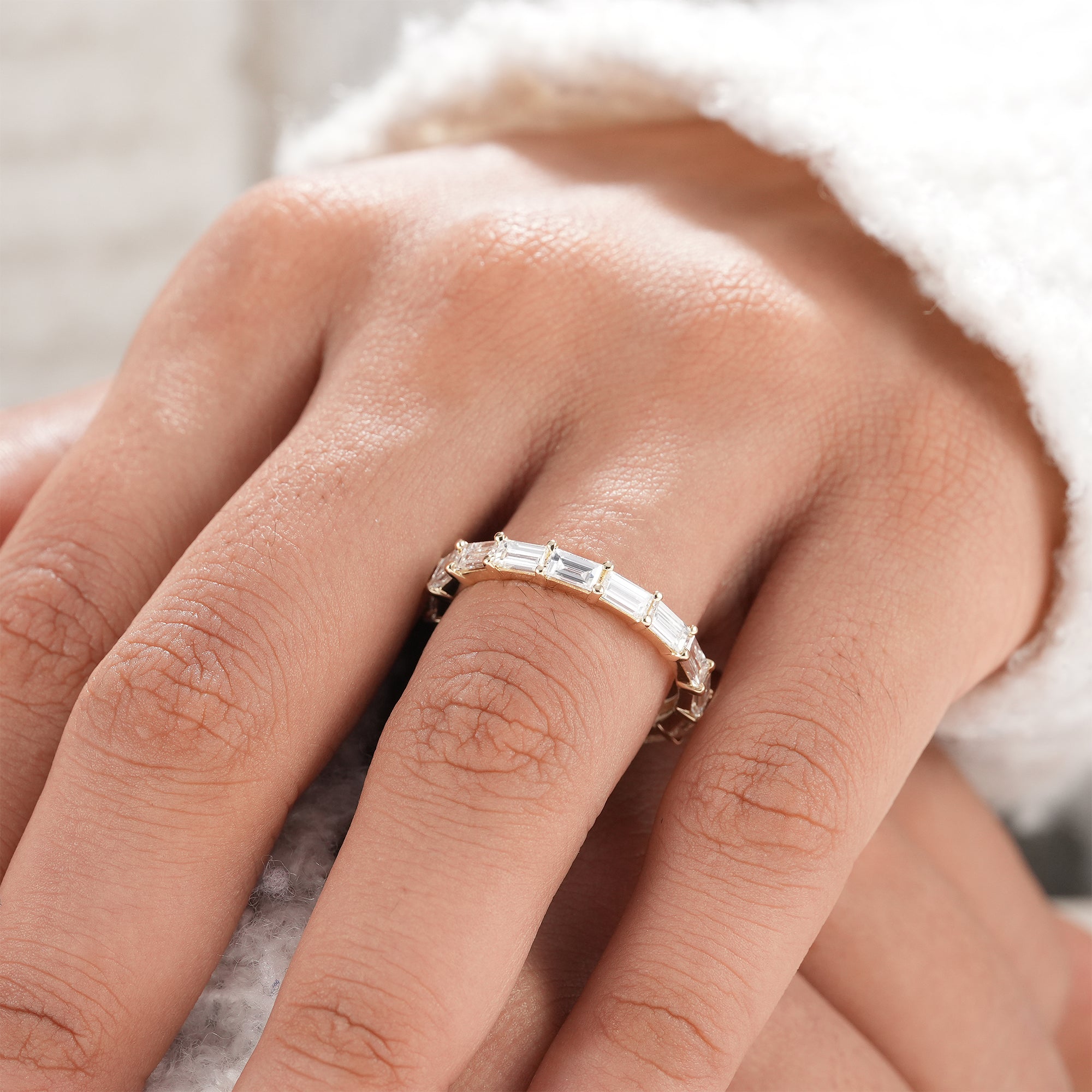 Minimalist eternity band featuring baguette cut diamonds.