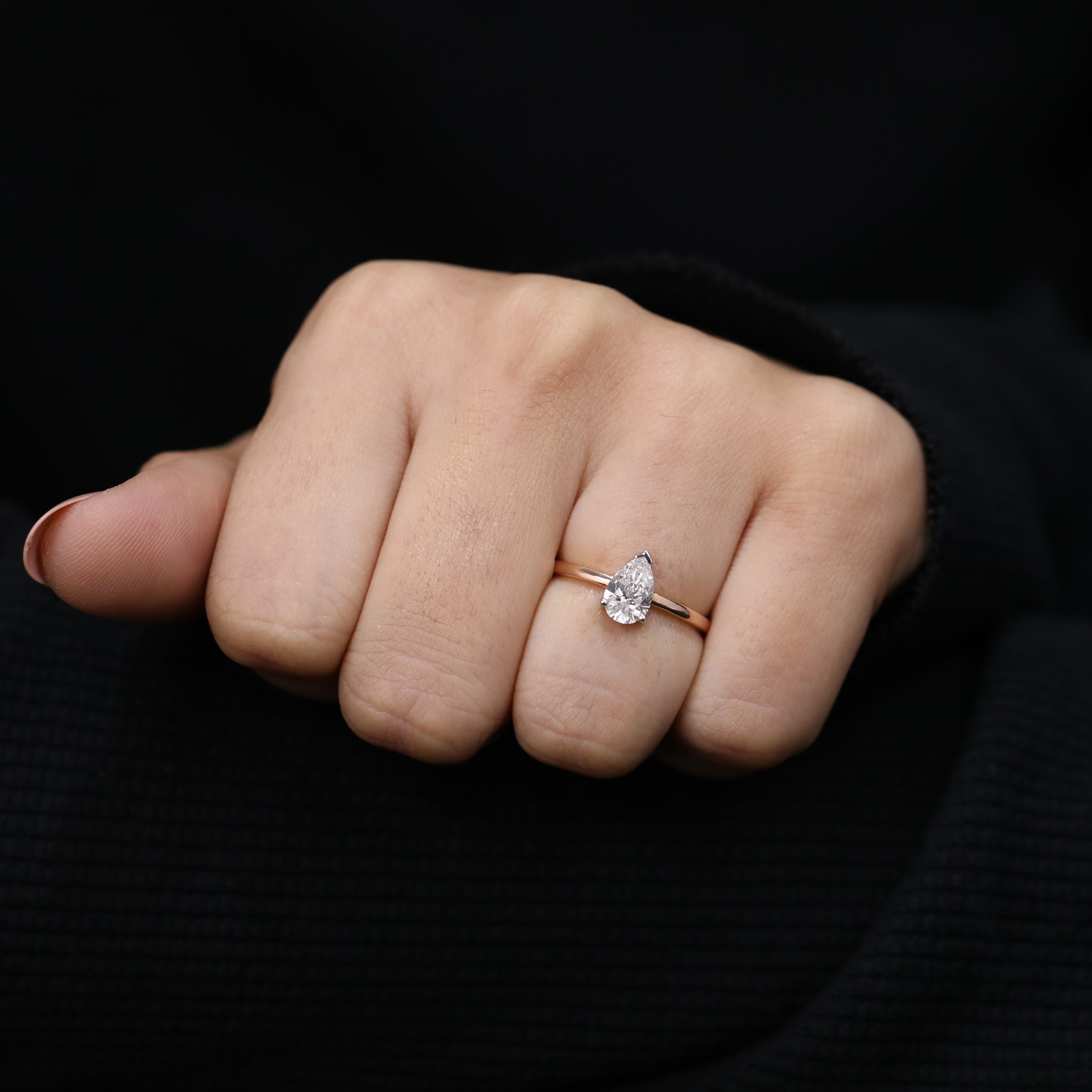 Minimal solitaire engagement ring showcasing pear lab grown diamond