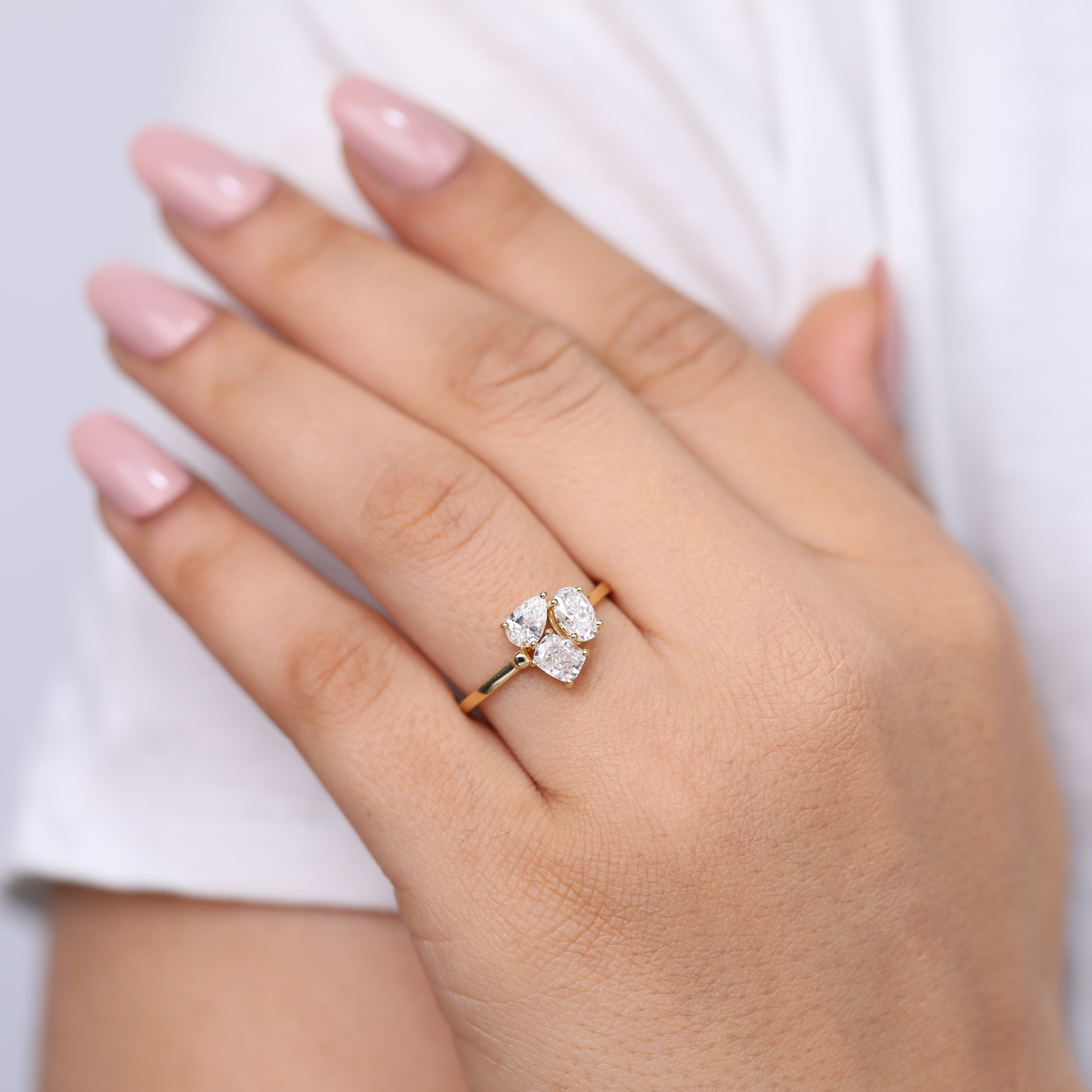 Modern lab grown diamond oval solitaire ring reimagined in a three-stone layout