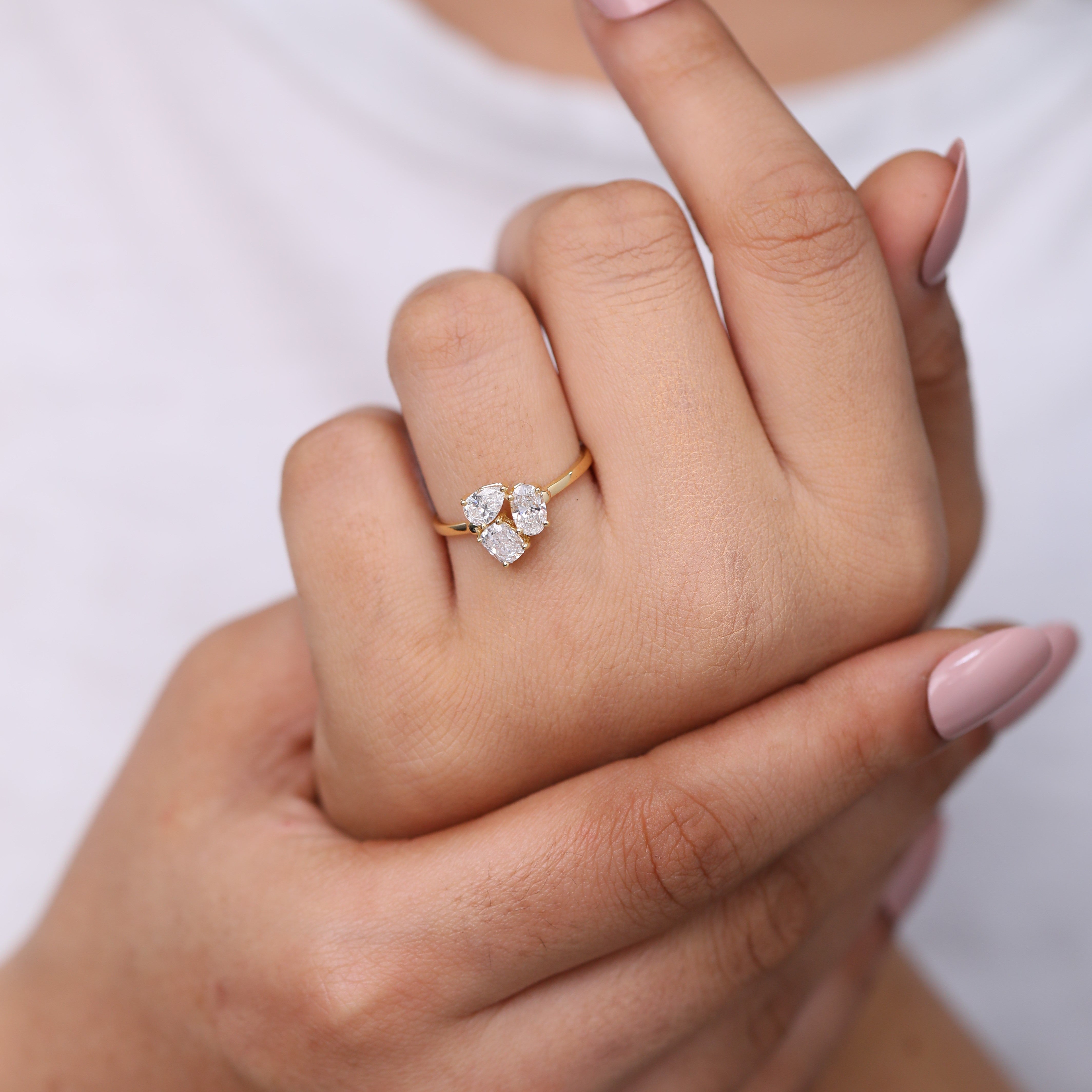 Statement oval lab grown diamond engagement ring with pear and cushion shapes