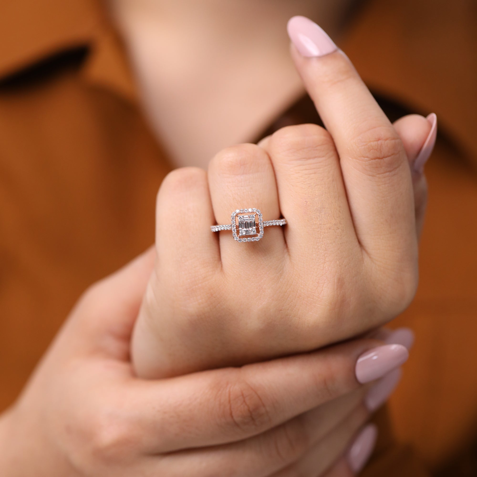 Rose gold ring featuring a baguette cluster lab grown diamond center and pavé halo